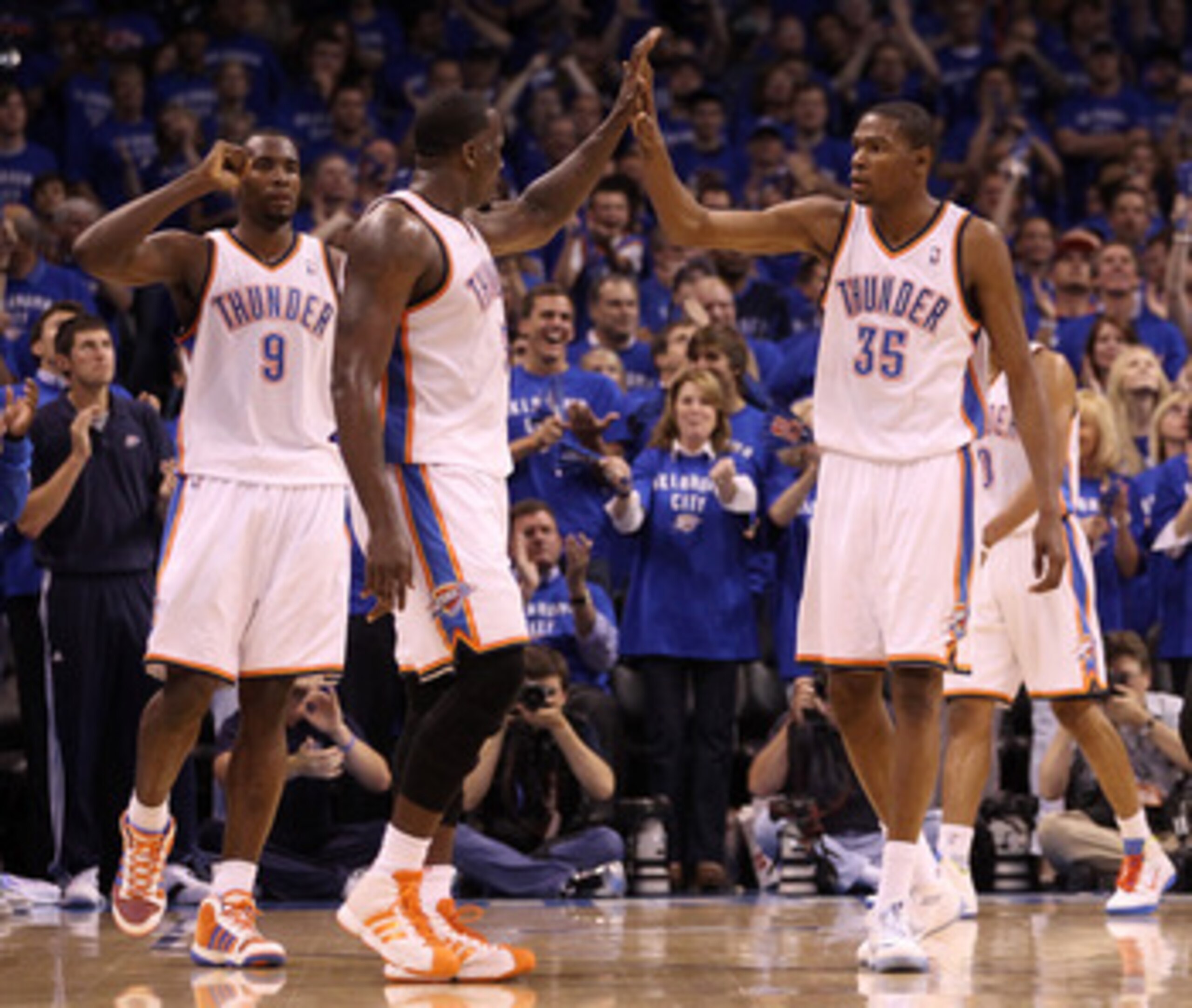OKLAHOMA CITY, OK - MAY 23:  (R-L) Kevin Durant #35, Kendrick Perkins #5, Serge Ibaka #9 of the Oklahoma City Thunder react in the second quarter while taking on the Dallas Mavericks in Game Four of the Western Conference Finals during the 2011 NBA Playof