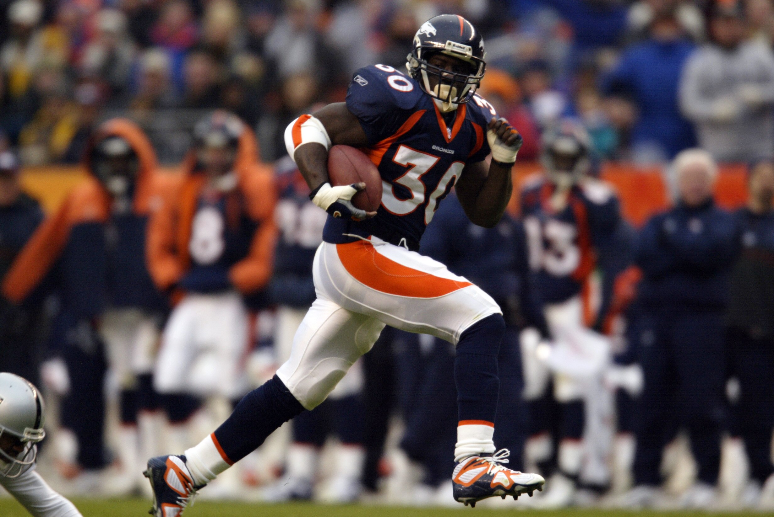 30 Dec 2001: Terrell Davis of the Denver Broncos gains yardage against the Oakland Raiders during the game at Invesco Field at Mile High Stadium in Denver, Colorado. The Broncos won 23-17. DIGITAL IMAGE. Mandatory Credit: Brian Bahr/Getty Images