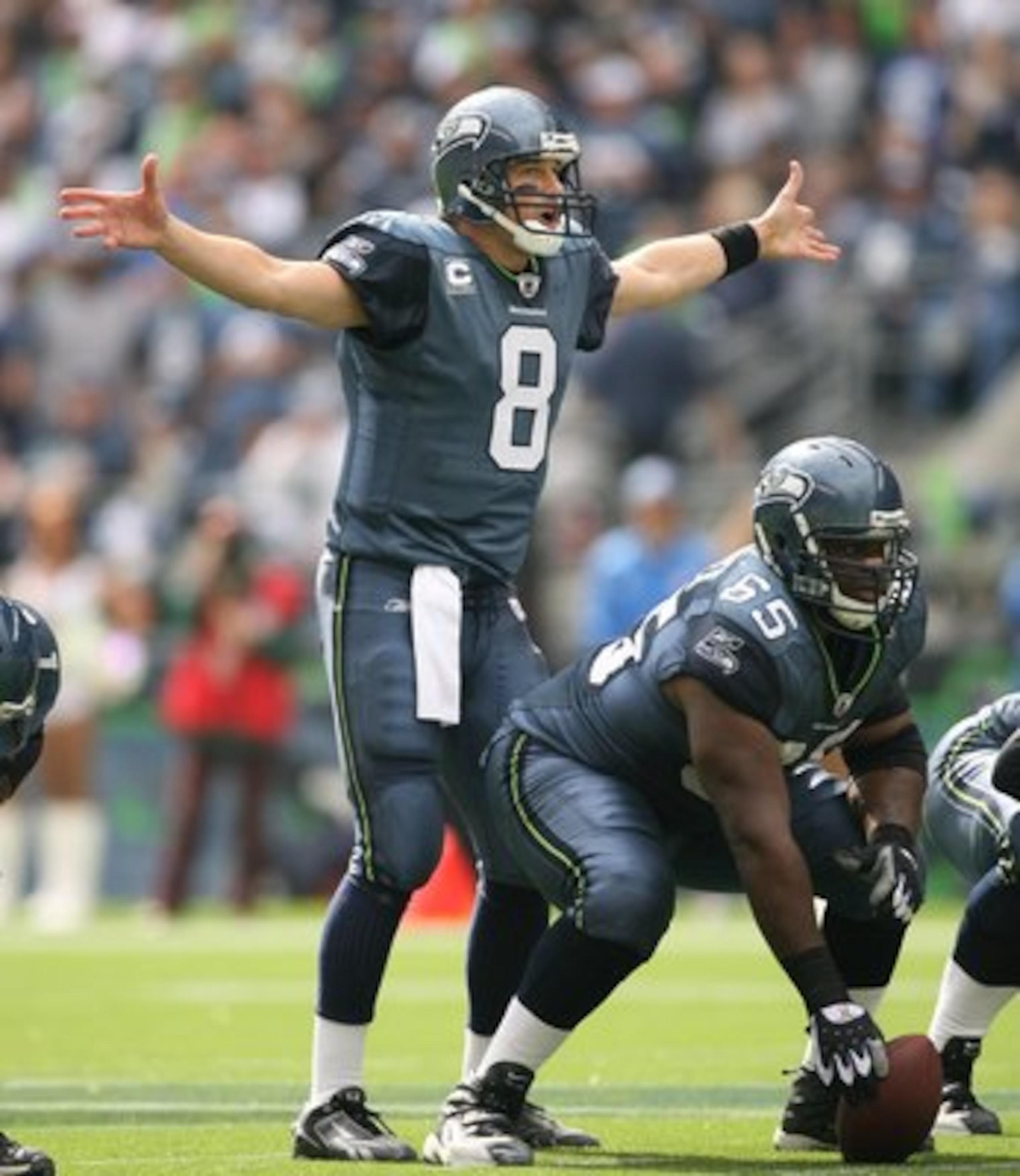 SEATTLE - SEPTEMBER 21:  Matt Hasselbeck #8 of the Seattle Seahawks gestures under center Chris Spencer #65 during the game against the St. Louis Rams on September 21, 2008 at Qwest Field in Seattle, Washington. (Photo by Otto Greule Jr/Getty Images)