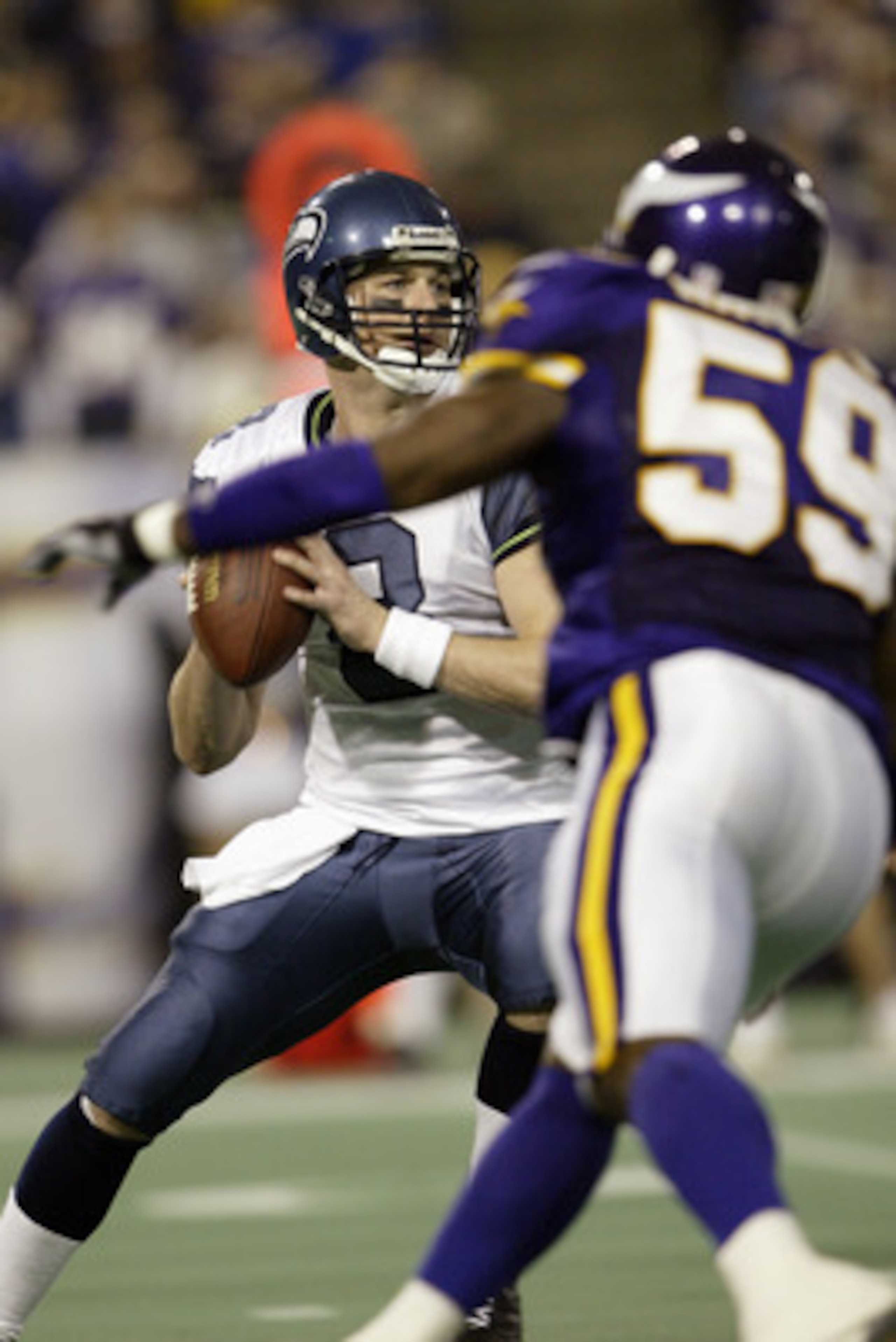 MINNEAPOLIS - DECEMBER 7:  Quarterback Matt Hasselbeck #8 of the Seattle Seahawks looks to get rid of the ball as linebacker Michael Nattiel #59 of the Minnesota Vikings on December 7, 2003 at the Hubert H. Humphrey Metrodome in Minneapolis, Minnesota. Th