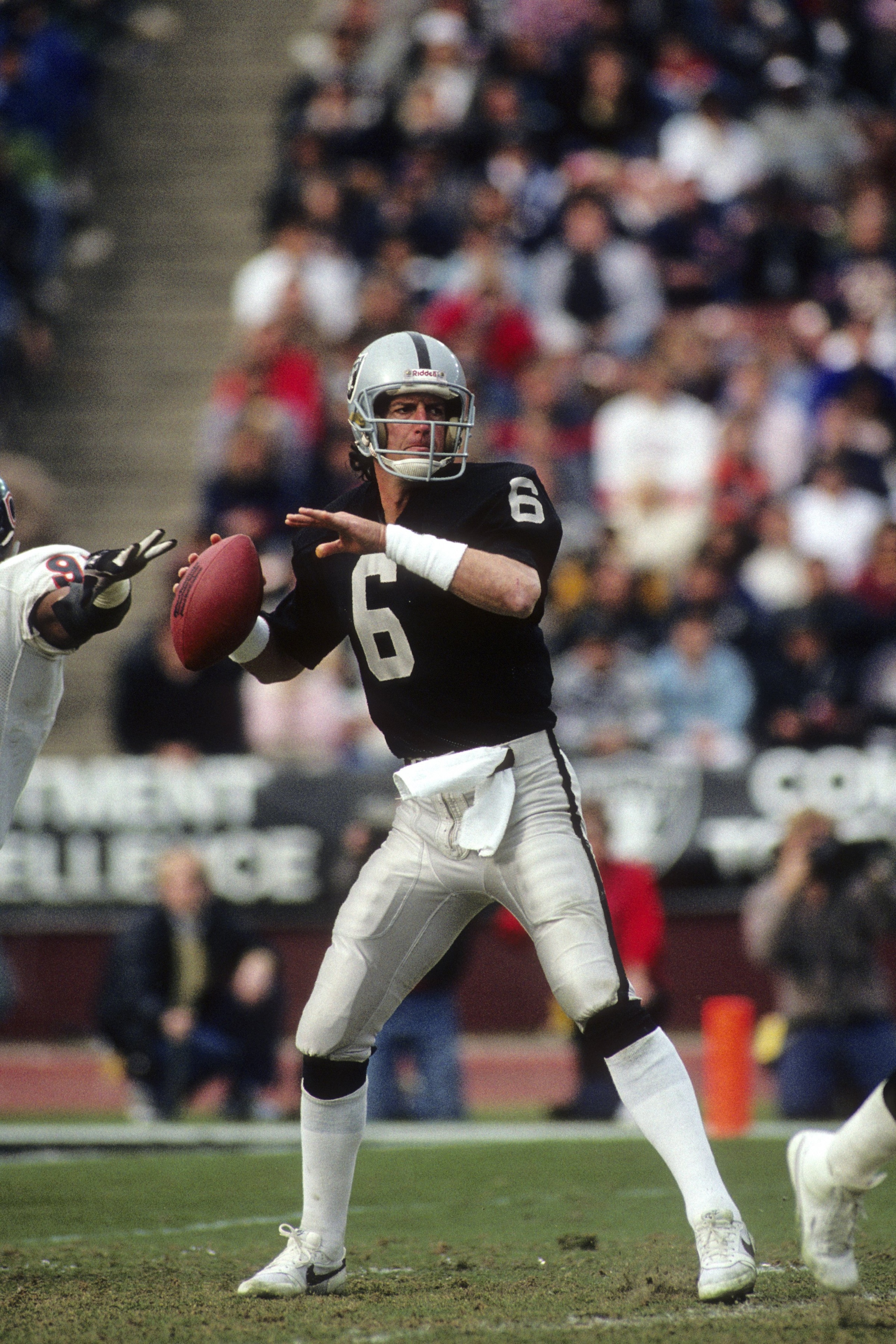 LOS ANGELES - DECEMBER 27:  Quarterback Marc Wilson #6 of the Los Angeles Raiders looks to pass the ball against the Chicago Bears during the game at the Los Angeles Memorial Coliseum on December 27, 1987 in Los Angeles, California.  The Bears won 6-3.  (