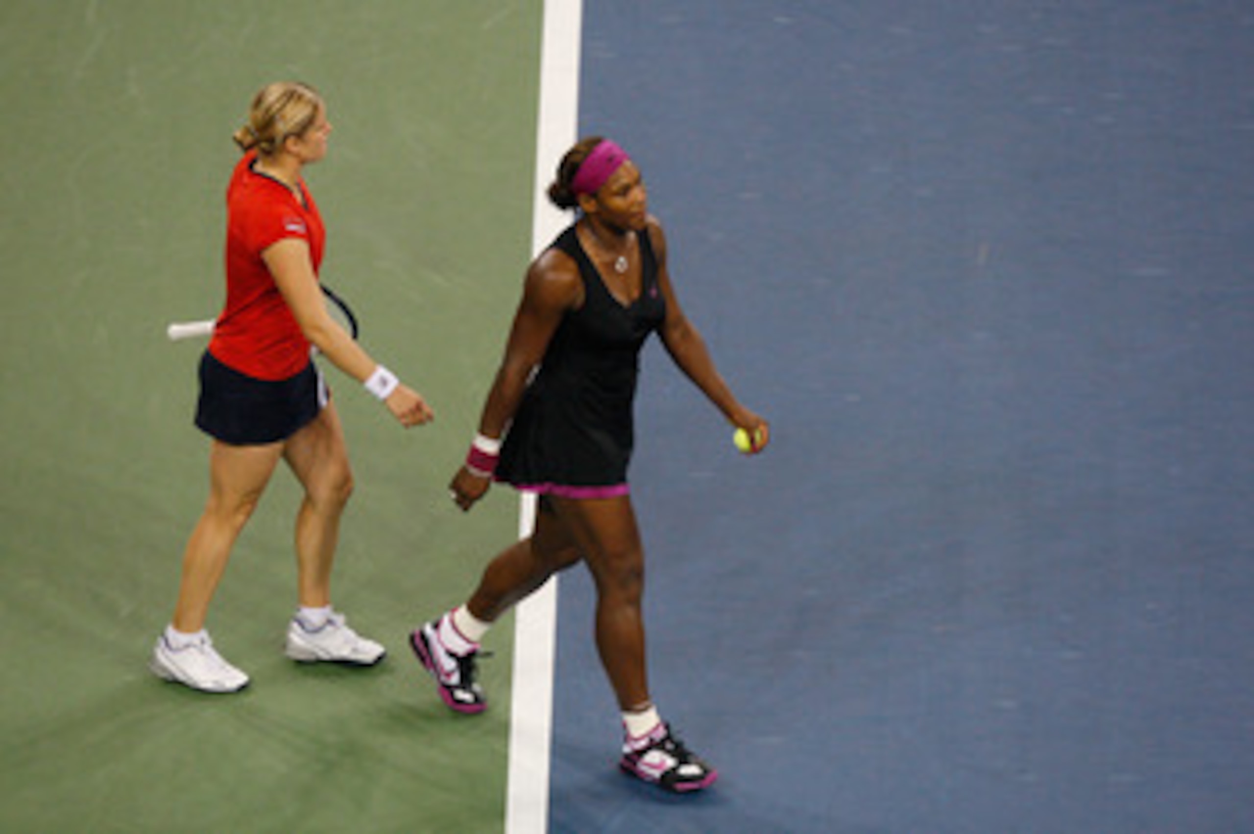NEW YORK - SEPTEMBER 12:  Serena Williams (R) walks away from Kim Clijsters of Belgium after Williams was disqualified for a conduct violation towards a line judge during the Women's Singles Semifinal match on day thirteen of the 2009 U.S. Open at the UST