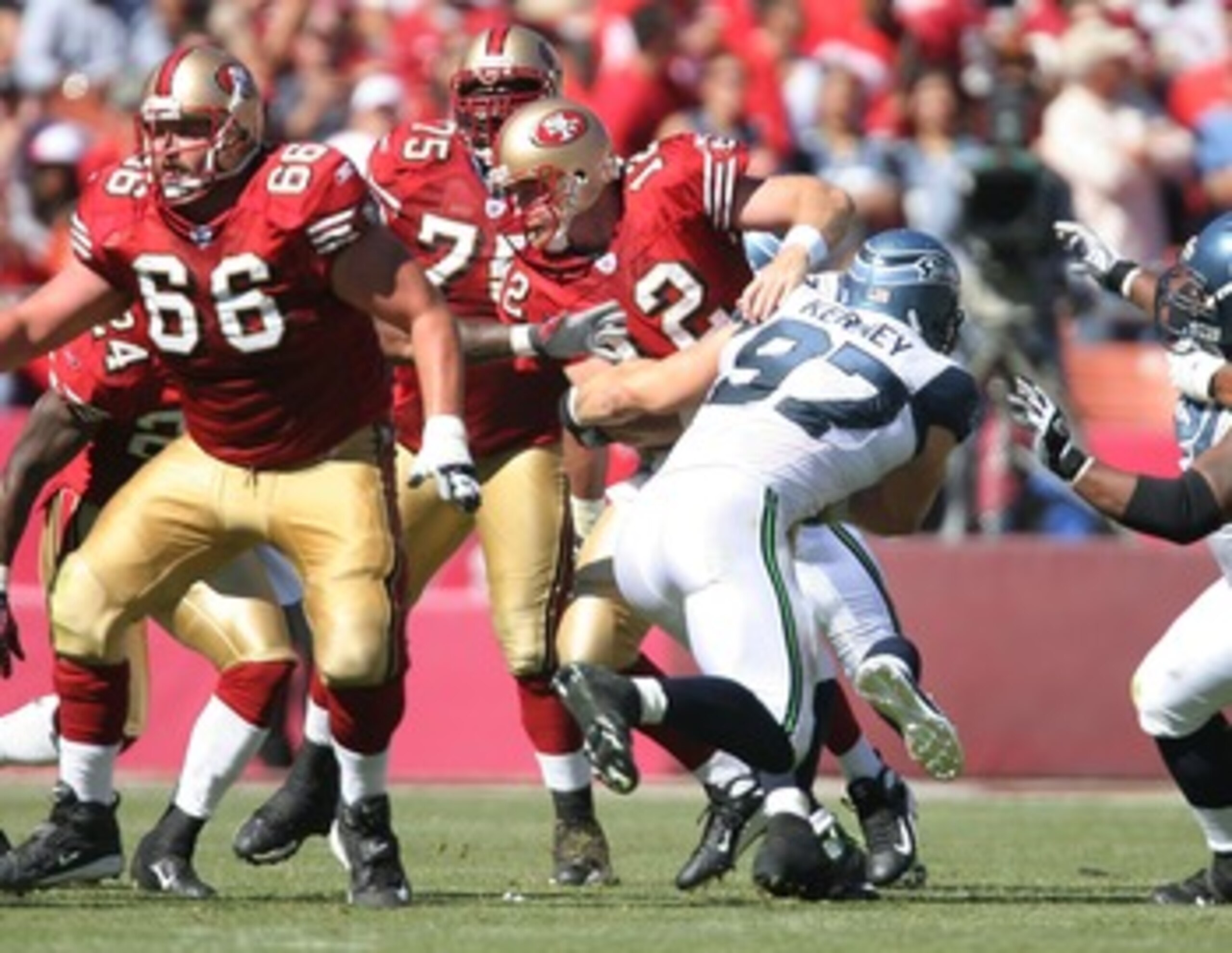 SAN FRANCISCO - SEPTEMBER 30:  Quarterback Trent Dilfer #12 of the San Francisco 49ers is sacked by defensive lineman Patrick Kerney #97 of the Seattle Seahawks at Monster Park September 30, 2007 in San Francisco, California.  (Photo by Greg Trott/Getty I