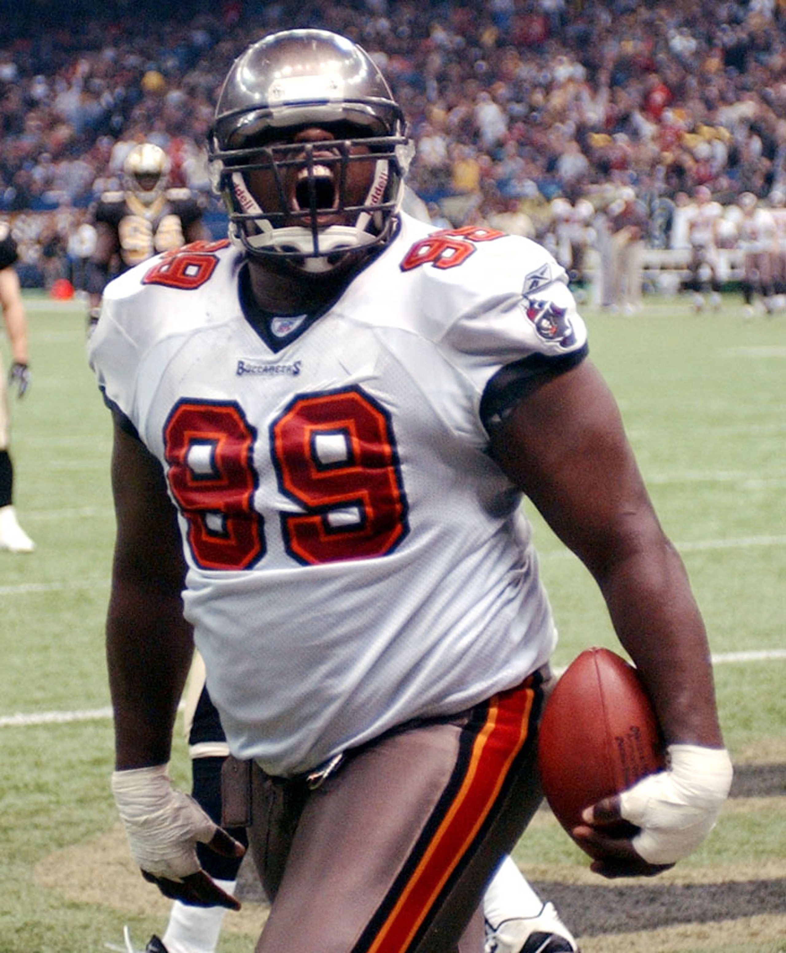 NEW ORLEANS, LA - DECEMBER 7:  Warren Sapp #99 of the Tampa Bay Buccaneers celebrates after catching a touchdown pass against the New Orleans Saints on December 7, 2003 at the Superdome in New Orleans, Louisiana.  (Photo by Chris Graythen/Getty Images)