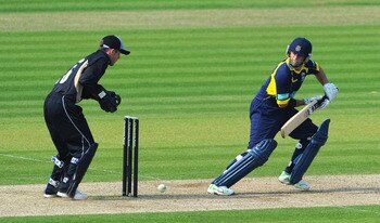 SOUTHAMPTON, ENGLAND - APRIL 24:  Neil McKenzie of Hamphire strikes a boundary as wicketkeeper Richard Johnson of Warwickshire looks on during the Clydesdale Bank 40 match between Hampshire and Warwickshire at The Rose Bowl on April 24, 2011 in Southampto