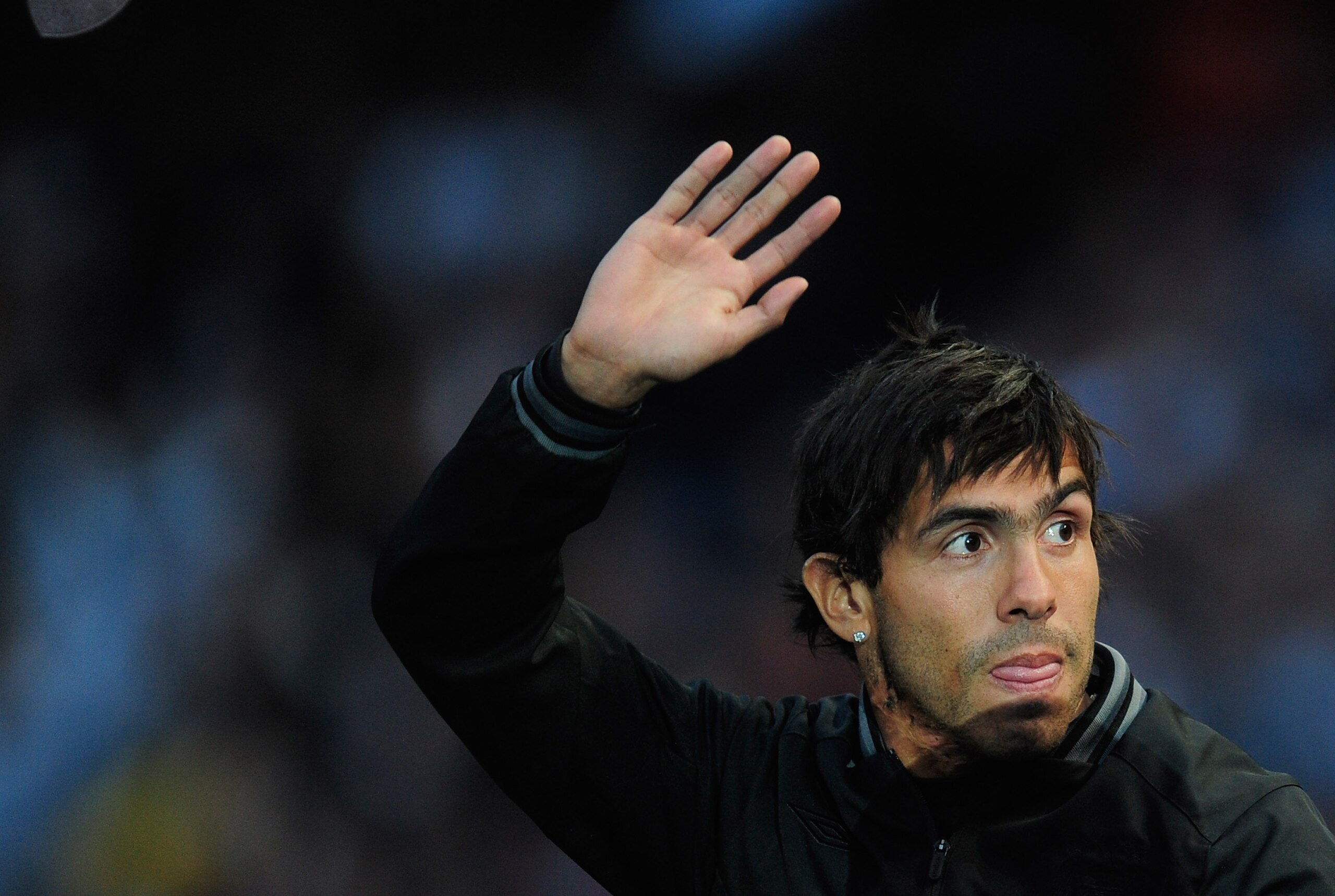 MANCHESTER, ENGLAND - MAY 23:  Carlos Tevez of Manchester City waves to the fans during the Manchester City FA Cup Winners Parade at the City of Manchester stadium on May 23, 2011 in Manchester, United Kingdom.  (Photo by Jamie McDonald/Getty Images)
