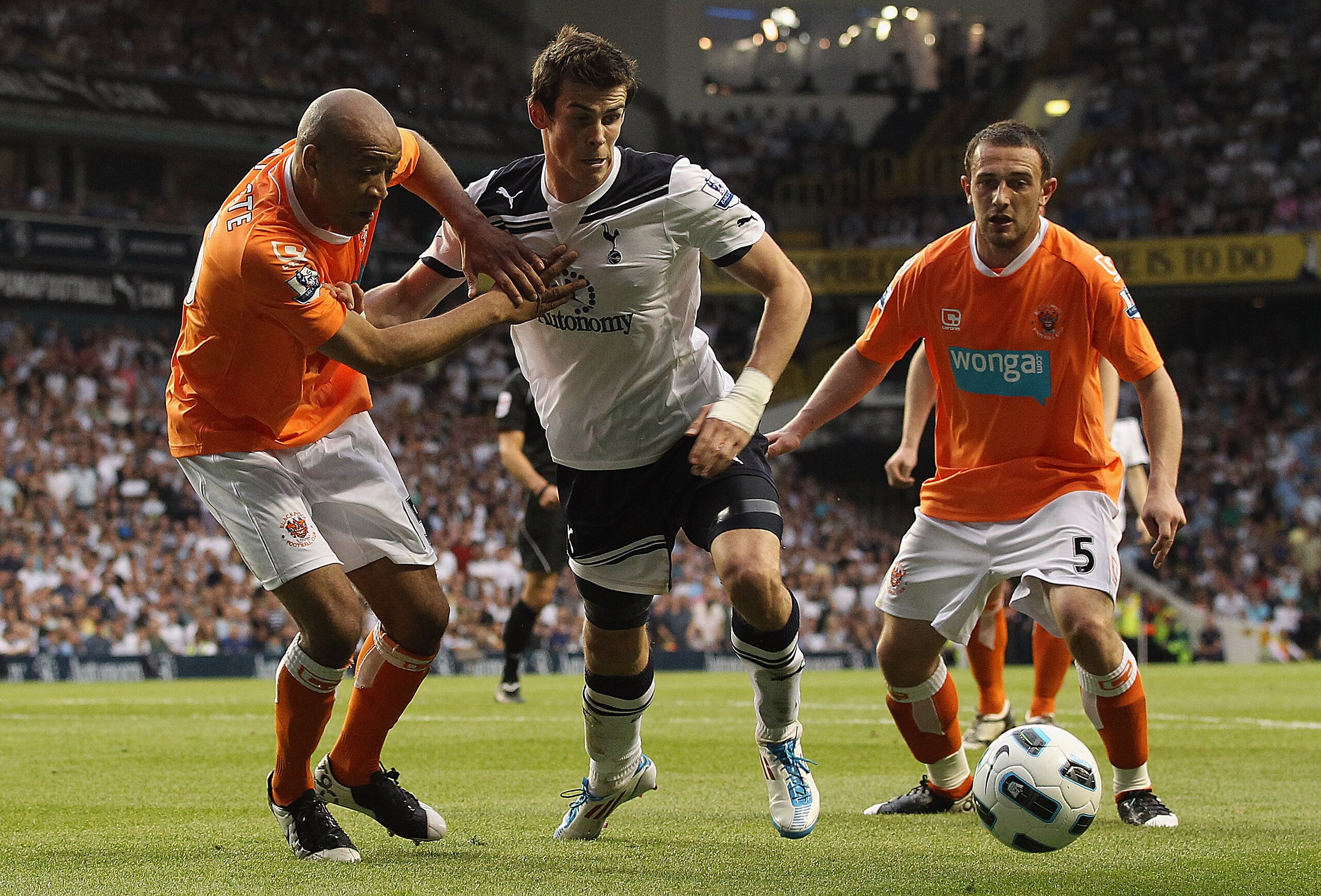 LONDON, UNITED KINGDOM - MAY 07: Gareth Bale of Spurs tries to find a way through Neal Eardley and Alex Baptiste of Blackpool during the Barclays Premier League match between Tottenham Hotspur and Blackpool at White Hart Lane on May 7, 2011 in London, Eng