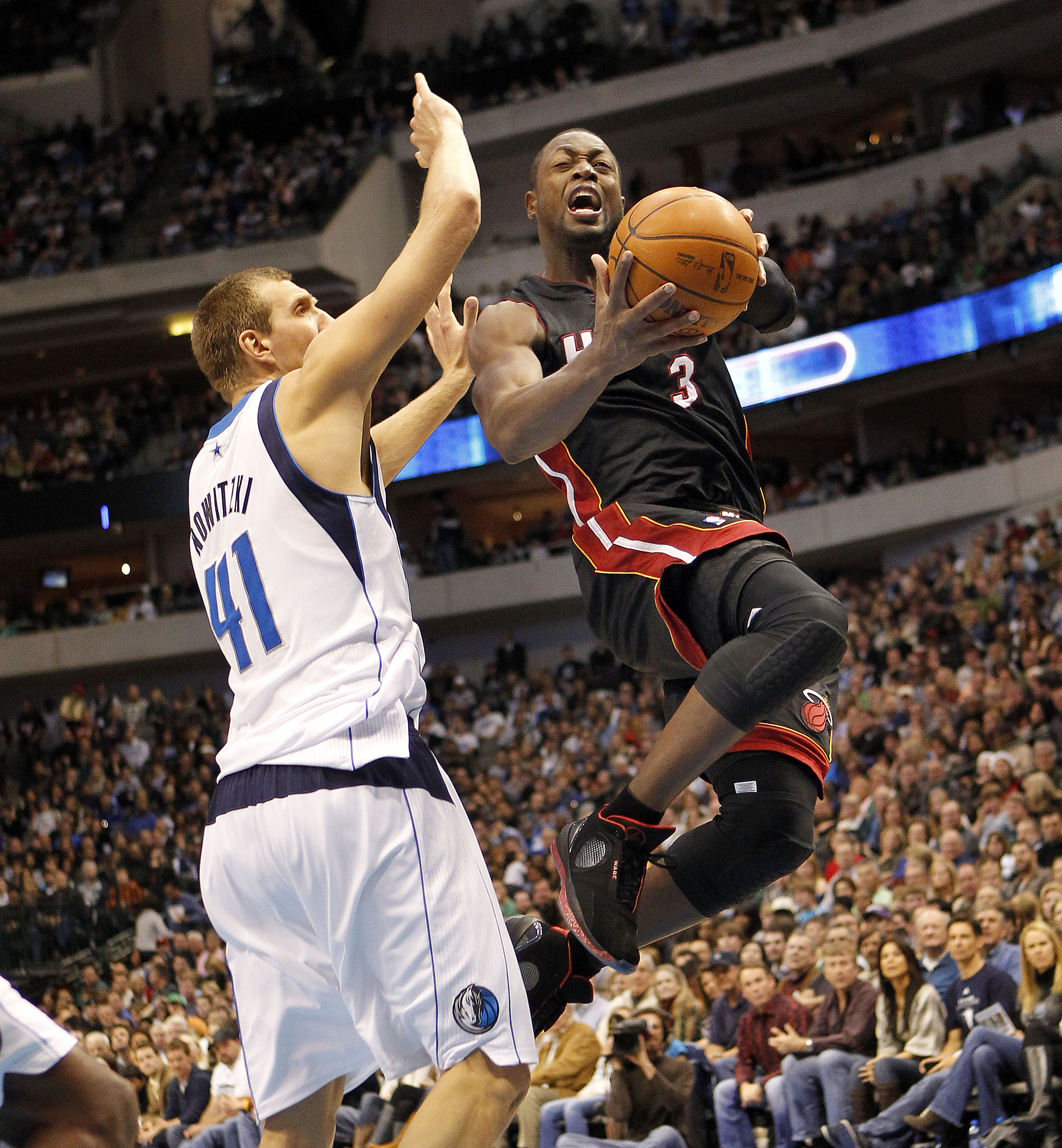 DALLAS - NOVEMBER 27: Dwyane Wade #3 of the Miami Heat drives by Dirk Nowitzki #41 of the Dallas Mavericks on November 27, 2010 at the American Airlines Center in Dallas, Texas. NOTE TO USER: User expressly acknowledges and agrees that, by downloading and