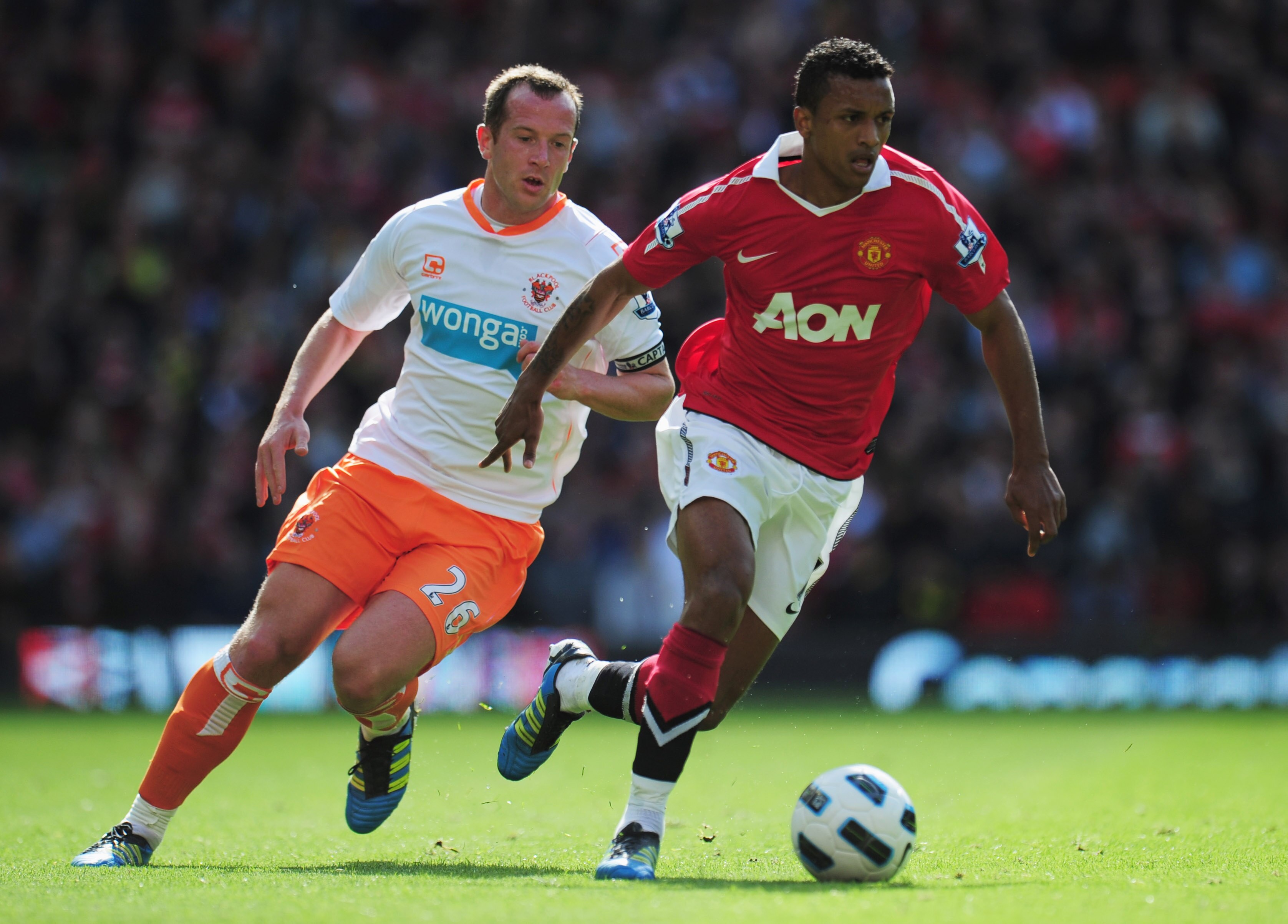 MANCHESTER, ENGLAND - MAY 22:  Luis Nani of Manchester United evades Charlie Adam of Blackpool during the Barclays Premier League match between Manchester United and Blackpool at Old Trafford on May 22, 2011 in Manchester, England.  (Photo by Shaun Botter