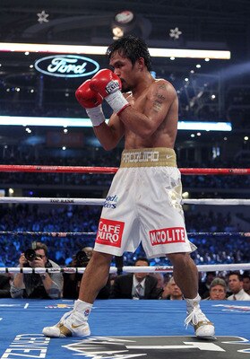 ARLINGTON, TX - NOVEMBER 13:  Manny Pacquiao (white trunks) of the Philippines fights against Antonio Margarito of Mexico during their WBC World Super Welterweight Title bout at Cowboys Stadium on November 13, 2010 in Arlington, Texas.  (Photo by Nick Lah