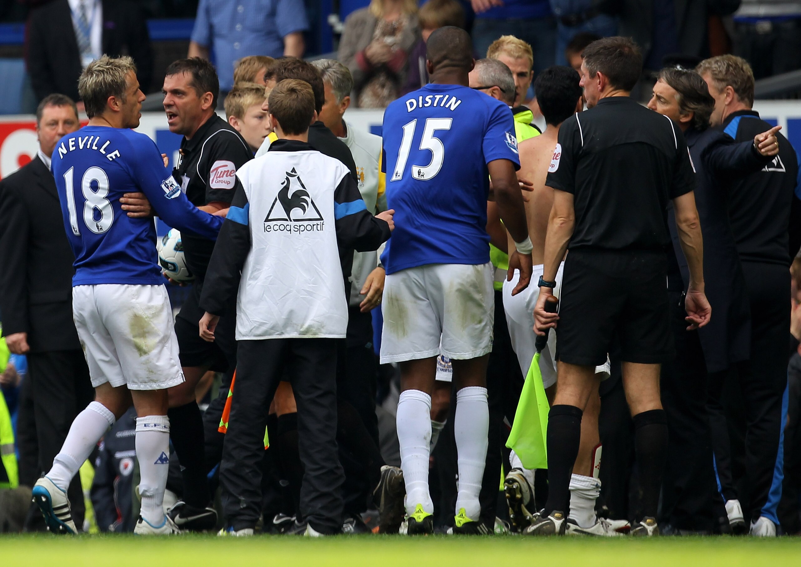 LIVERPOOL, ENGLAND - MAY 07:  Phillip Neville of Everton is restrained by Referee Phil Dowd as he argues with Manchester City Manager Roberto Mancini at the end of the Barclays Premier League match between Everton and Manchester City at Goodison Park on M
