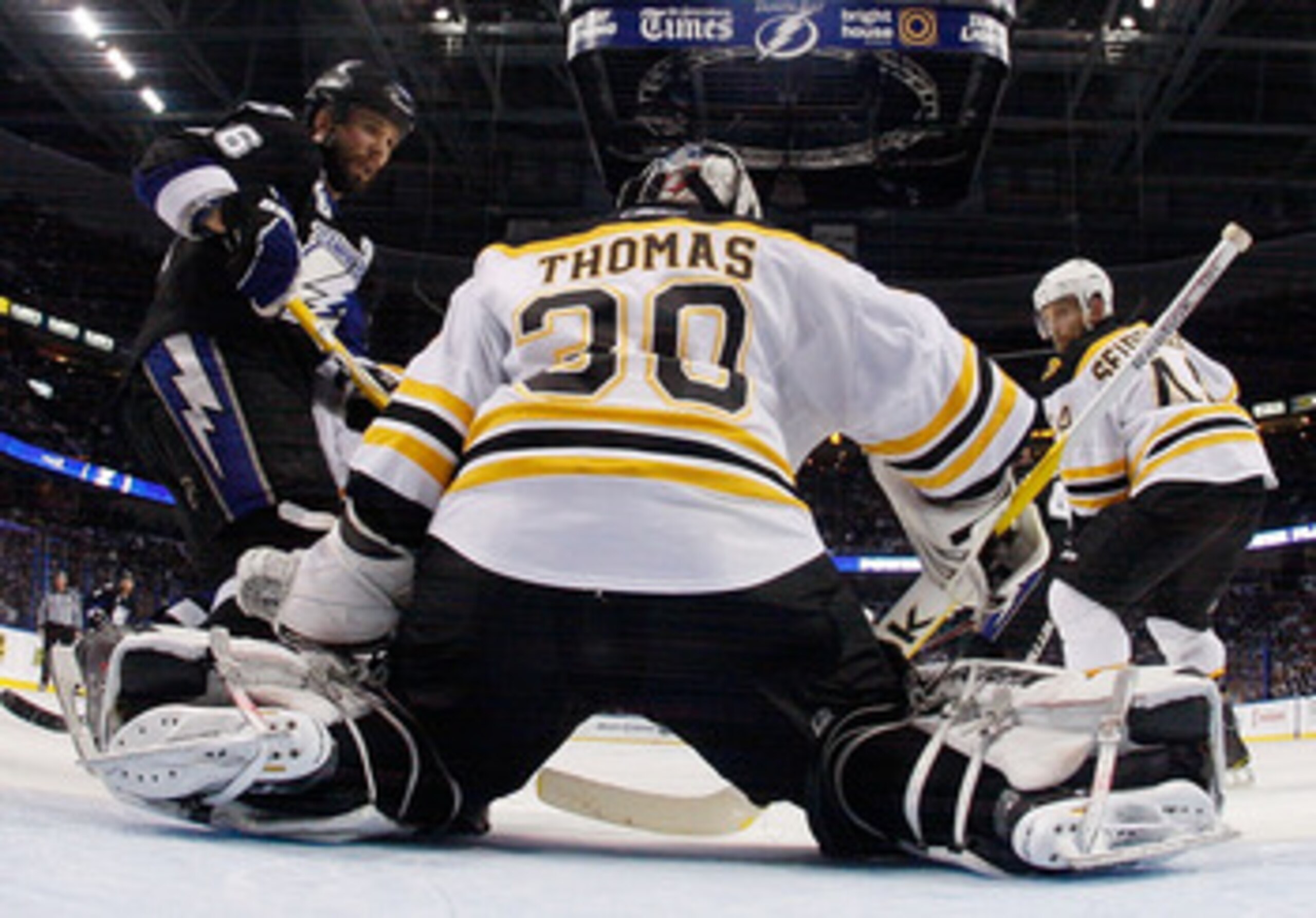 TAMPA, FL - MAY 25:  Dennis Seidenberg #44 and Tim Thomas #30 of the Boston Bruins defend against Martin St. Louis #26 of the Tampa Bay Lightning in Game Six of the Eastern Conference Finals during the 2011 NHL Stanley Cup Playoffs at St Pete Times Forum