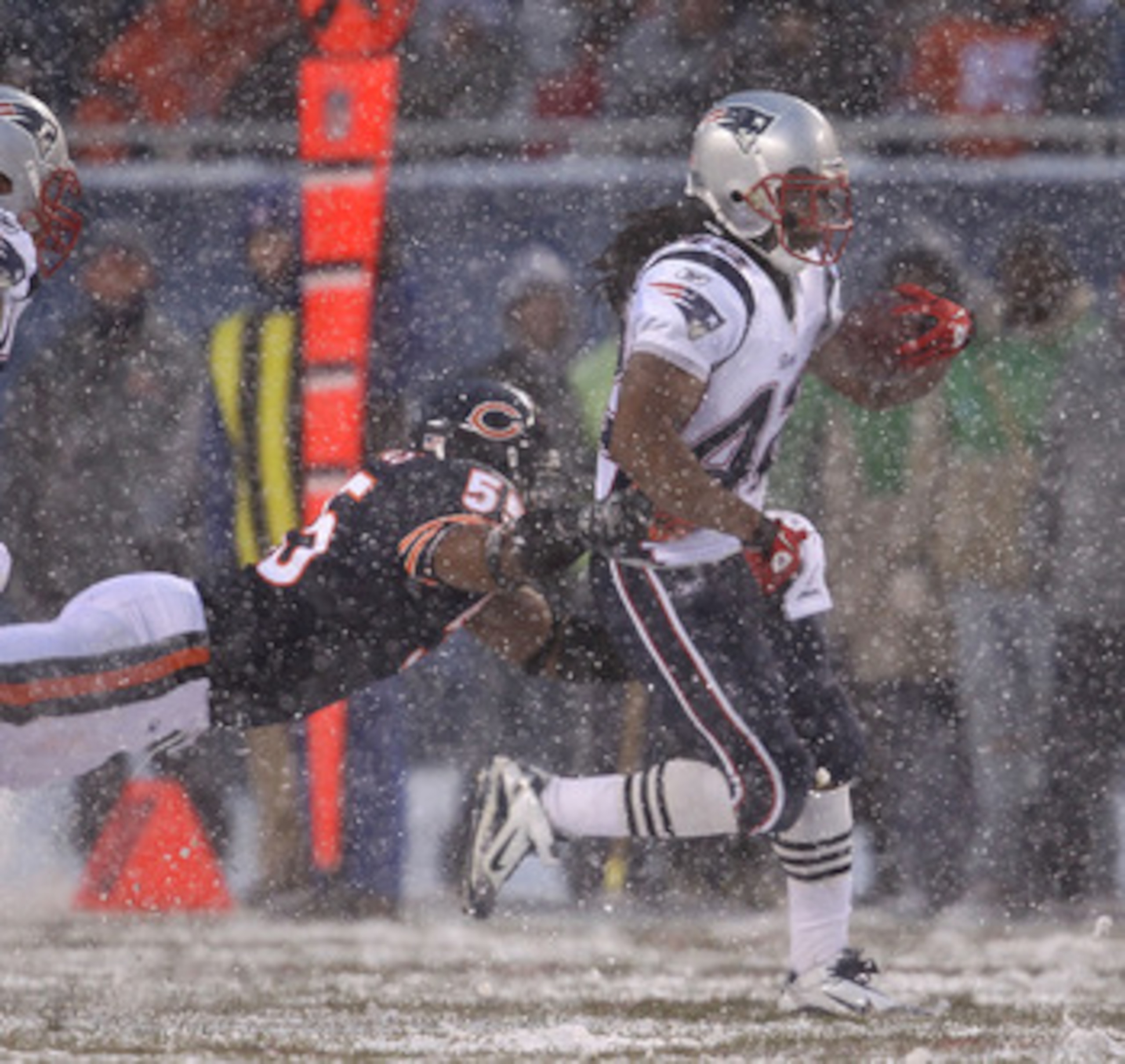 CHICAGO, IL - DECEMBER 12: BenJarvus Green-Ellis #42 of the New England Patriots breaks away from Lance Briggs #55 of the Chicago Bears at Soldier Field on December 12, 2010 in Chicago, Illinois. The Patriots defeated the Bears 36-7. (Photo by Jonathan Da