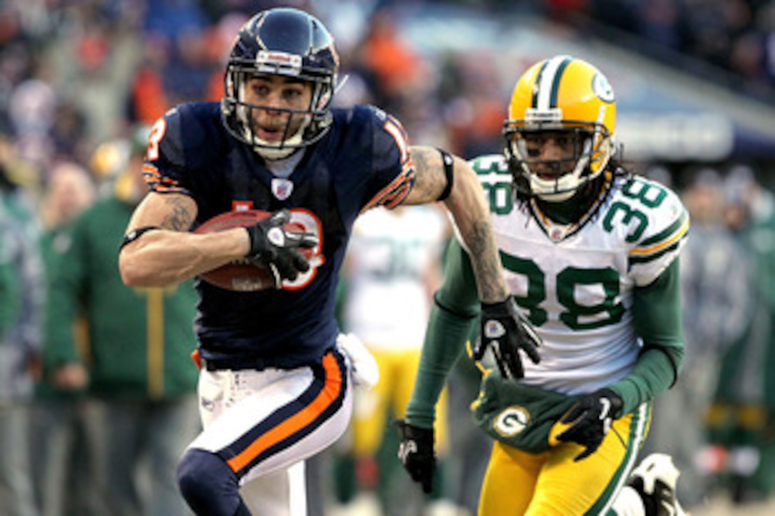 CHICAGO, IL - JANUARY 23:  Johnny Knox #13 of the Chicago Bears runs ahead of Tramon Williams #38 of the Green Bay Packers for a 32-yard gain in the fourth quarter in the NFC Championship Game at Soldier Field on January 23, 2011 in Chicago, Illinois.  (P
