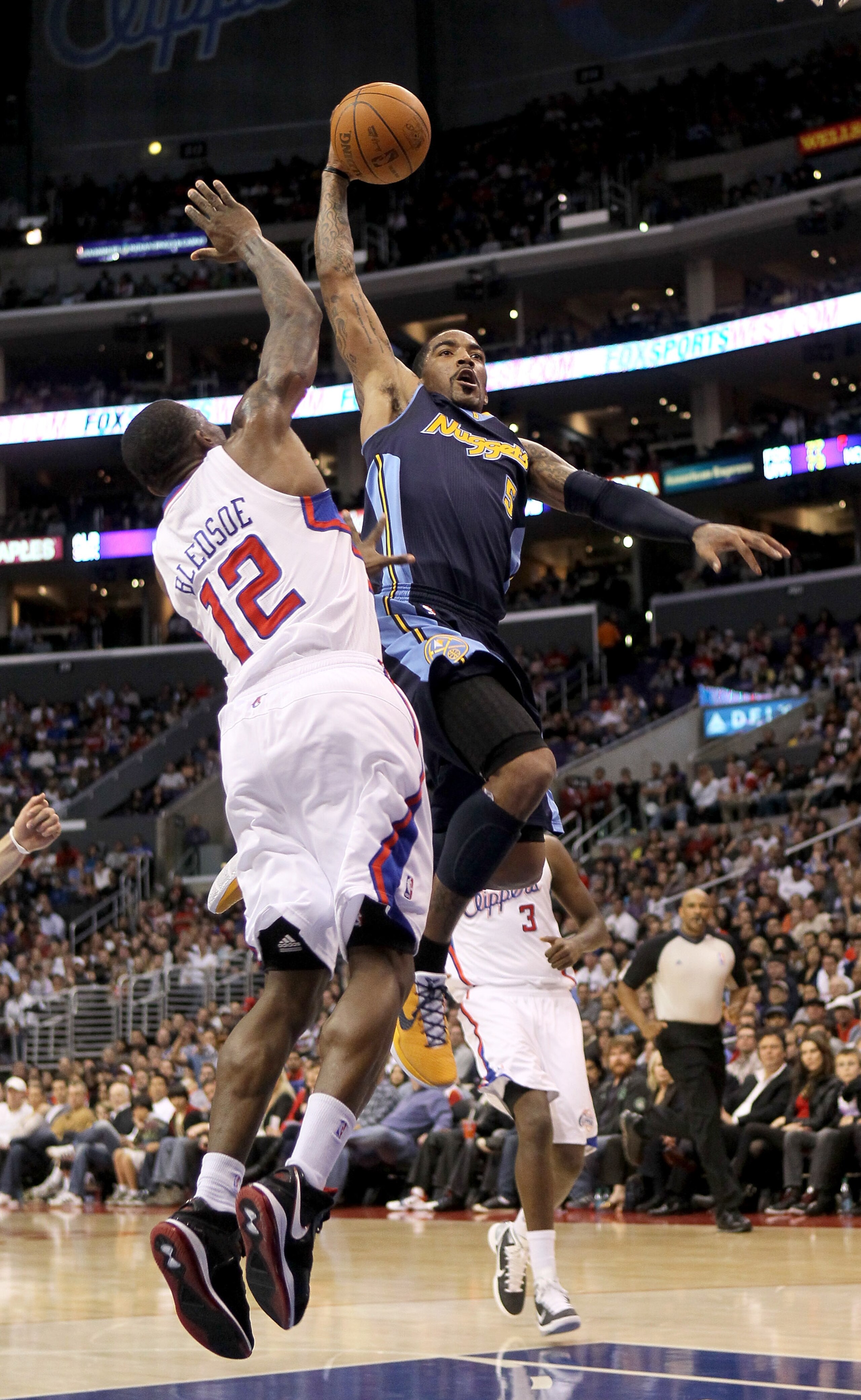 LOS ANGELES, CA - MARCH 5:   J.R. Smith #5 of the Denver Nuggets goes up for a shot against Eric Bledesoe #12 of the Los Angeles Clippers at Staples Center on March 5, 2011 in Los Angeles, California. The Clippers won 100-94. NOTE TO USER: User expressly