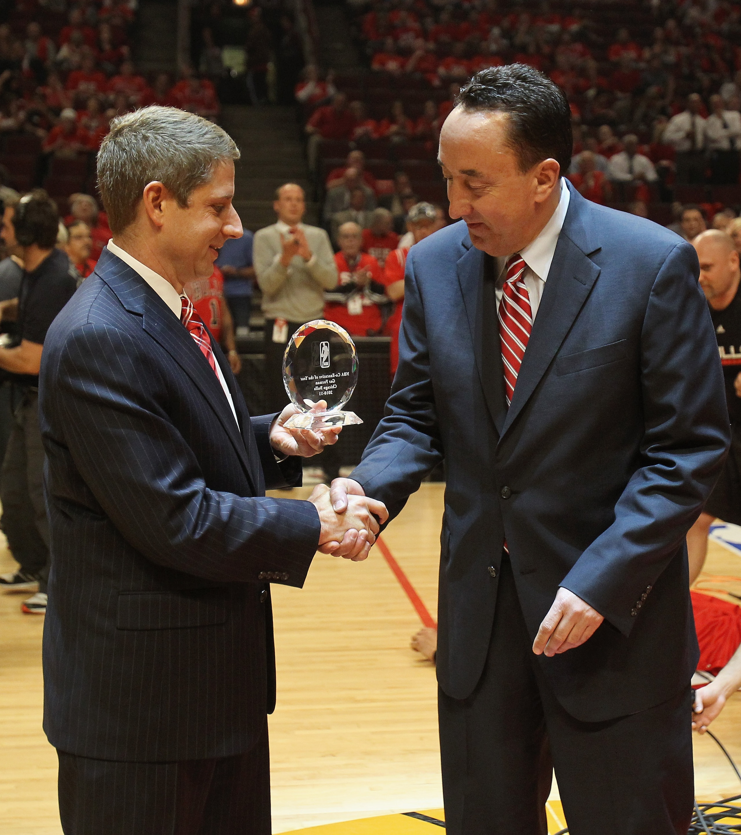 CHICAGO, IL - MAY 10: President and Chief Operating Officer Michael Reinsdorf of the Chicago Bulls (L) gives the NBA co- Executive of the Year award to general manager Gar Forman before the Bulls take on the Atlanta Hawks in Game Five of the Eastern Confe