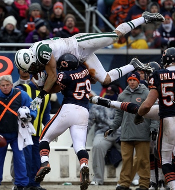 CHICAGO, IL - DECEMBER 26: Dustin Keller #81 of the New York Jets goes airbourne over Pisa Tinoisamoa #59 of the Chicago Bears for a first down at Soldier Field on December 26, 2010 in Chicago, Illinois. The Bears defeated the Jets 38-34. (Photo by Jonath