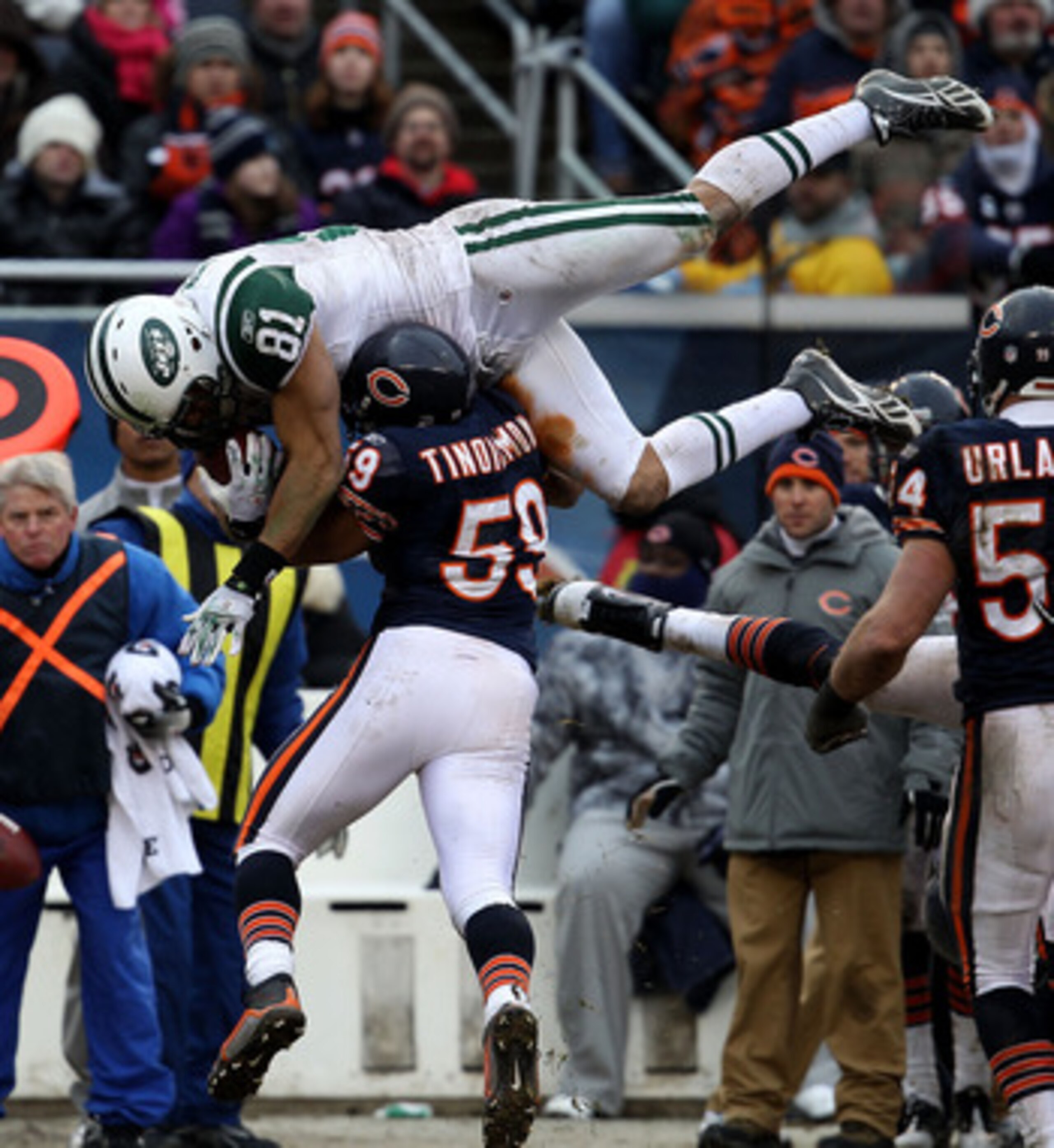 CHICAGO, IL - DECEMBER 26: Dustin Keller #81 of the New York Jets goes airbourne over Pisa Tinoisamoa #59 of the Chicago Bears for a first down at Soldier Field on December 26, 2010 in Chicago, Illinois. The Bears defeated the Jets 38-34. (Photo by Jonath