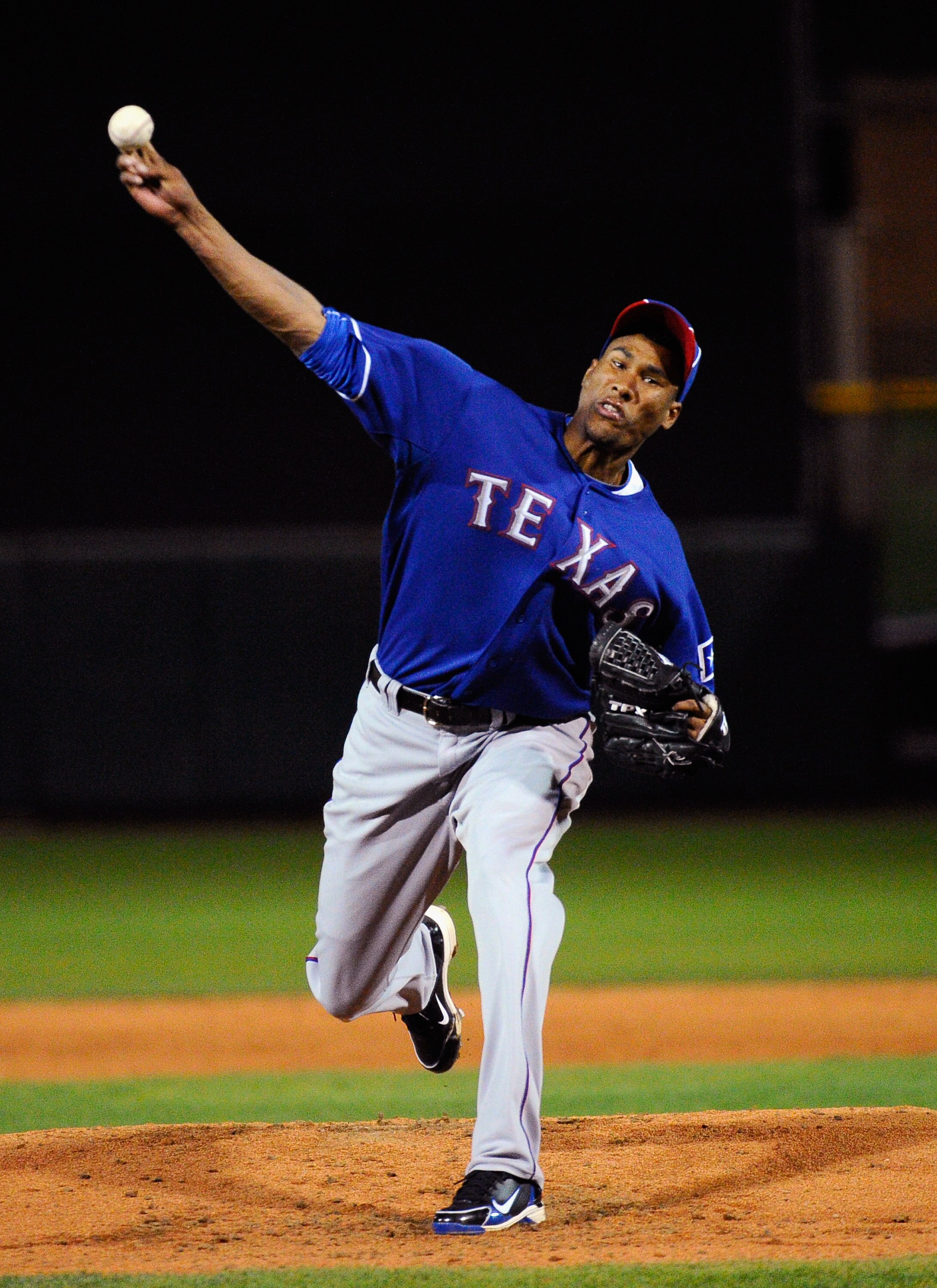 SCOTTSDALE, AZ - MARCH 07:  Pitcher Alexi Ogando #41 of the Texas Rangers throws a pitch against the San Francisco Giants in the first meeting between the two teams since the World Series at a spring training game at Scottsdale Stadium on March 7, 2011 in