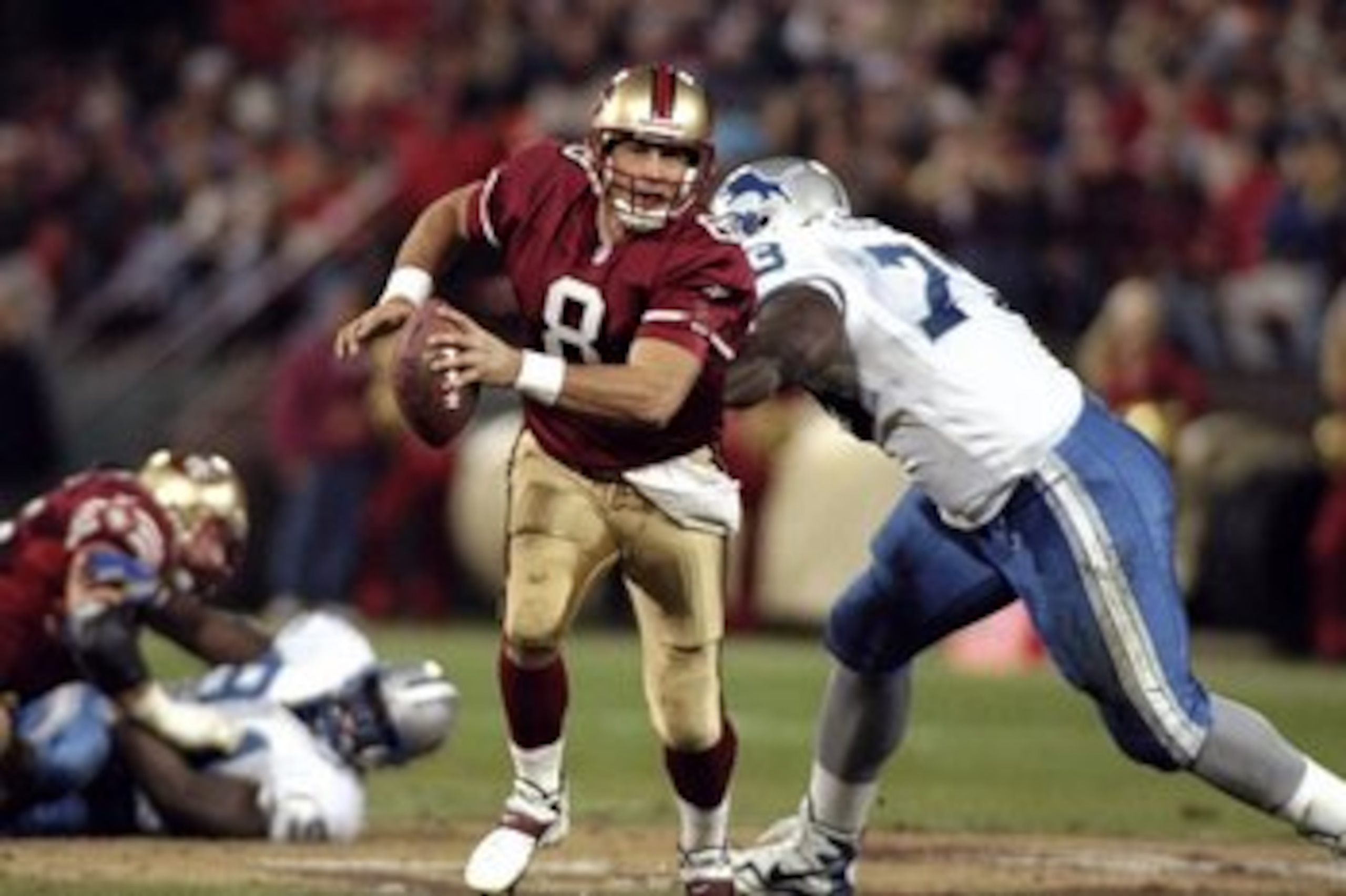 14 Dec 1998: Steve Young #8 of the San Francisco 49ers is sacked by Darrius Holland #73 of the Detroit Lions at 3Com Park in San Francisco, California. The 49ers defeated the Lions 35-13. Mandatory Credit: Jed Jacobsohn  /Allsport