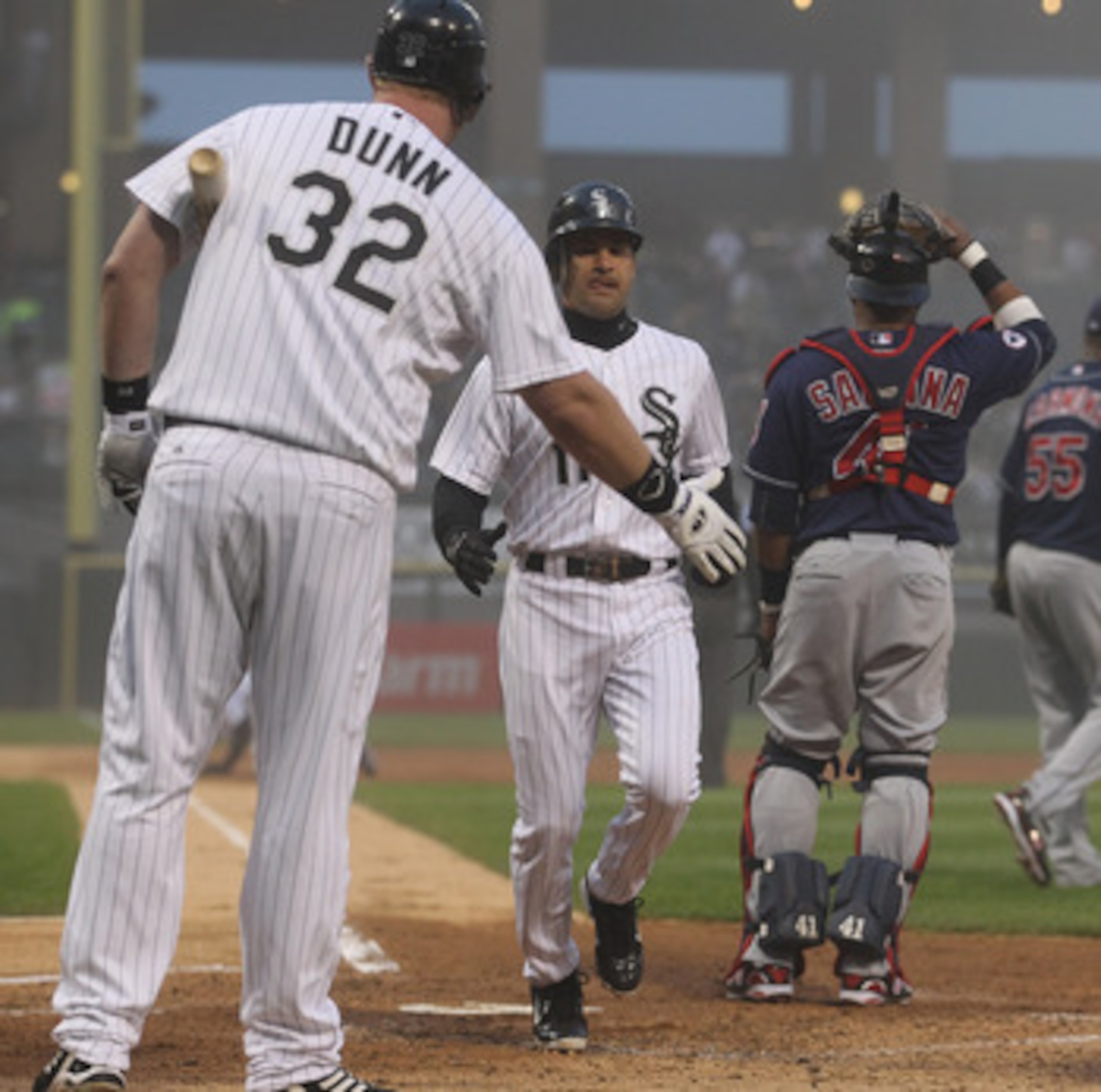 CHICAGO, IL - MAY 19: Adam Dunn #32 of the Chicago White Sox congratulates teammate Omar Vizquel #11 as he scores a run in the 2nd inning past Carlos Santana #41 of the Cleveland Indians at U.S. Cellular Field on May 19, 2011 in Chicago, Illinois. (Photo CHICAGO, IL - MAY 19: Adam Dunn #32 of the Chicago White Sox congratulates teammate Omar Vizquel #11 as he scores a run in the 2nd inning past Carlos Santana #41 of the Cleveland Indians at U.S. Cellular Field on May 19, 2011 in Chicago, Illinois. (Photo
