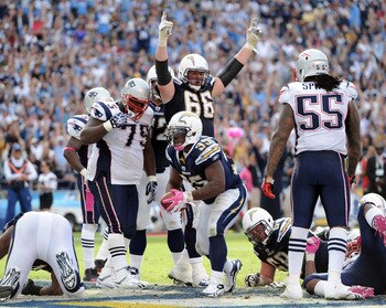 SAN DIEGO - OCTOBER 24:  Mike Tolbert #35 and Jeromey Clary #66 of the the San Diego Chargers react to a touchdown in front of Brandon Spikes #55 and Vince Wilfork #75 of the New England Patriots at Qualcomm Stadium on October 24, 2010 in San Diego, Calif