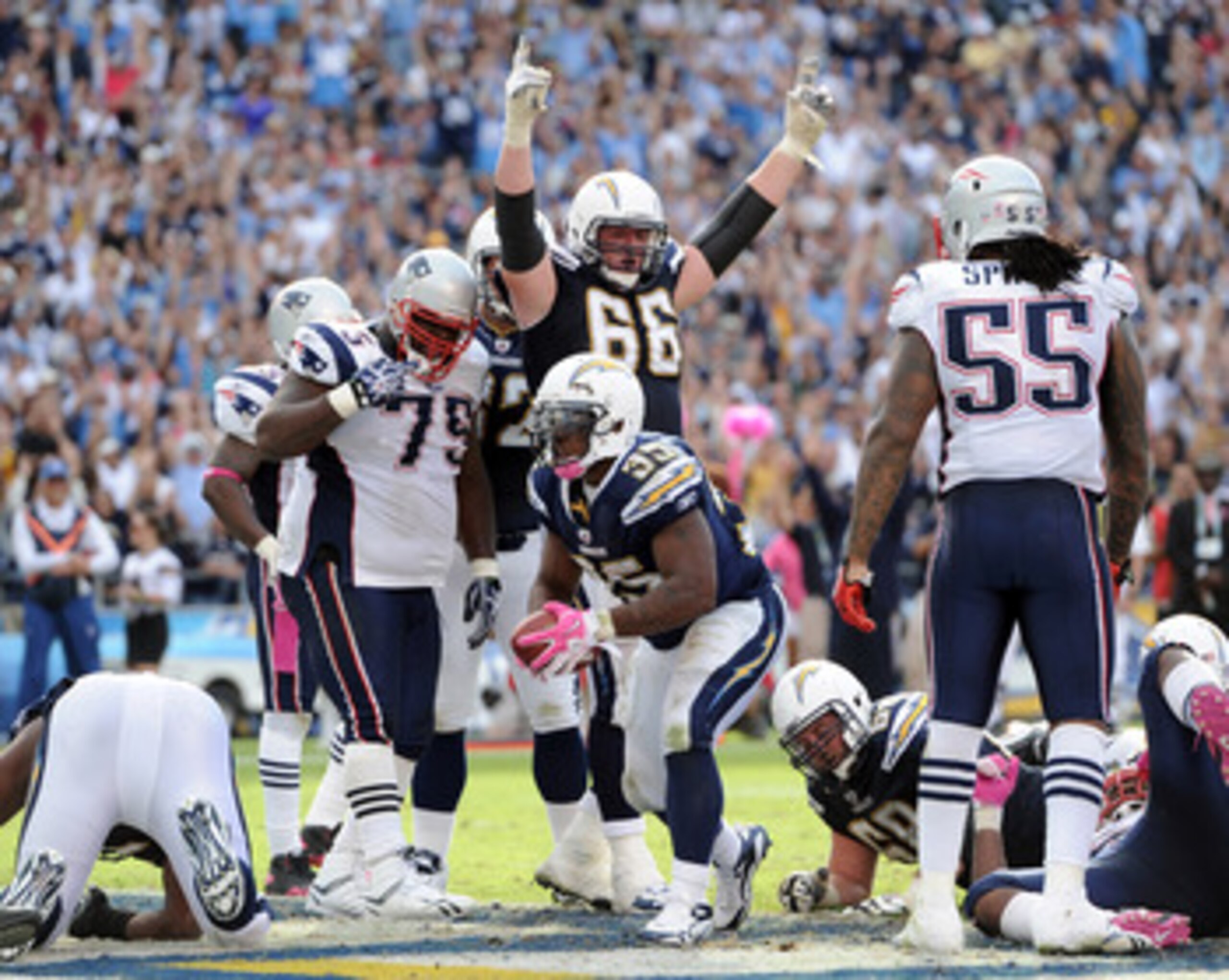 SAN DIEGO - OCTOBER 24:  Mike Tolbert #35 and Jeromey Clary #66 of the the San Diego Chargers react to a touchdown in front of Brandon Spikes #55 and Vince Wilfork #75 of the New England Patriots at Qualcomm Stadium on October 24, 2010 in San Diego, Calif