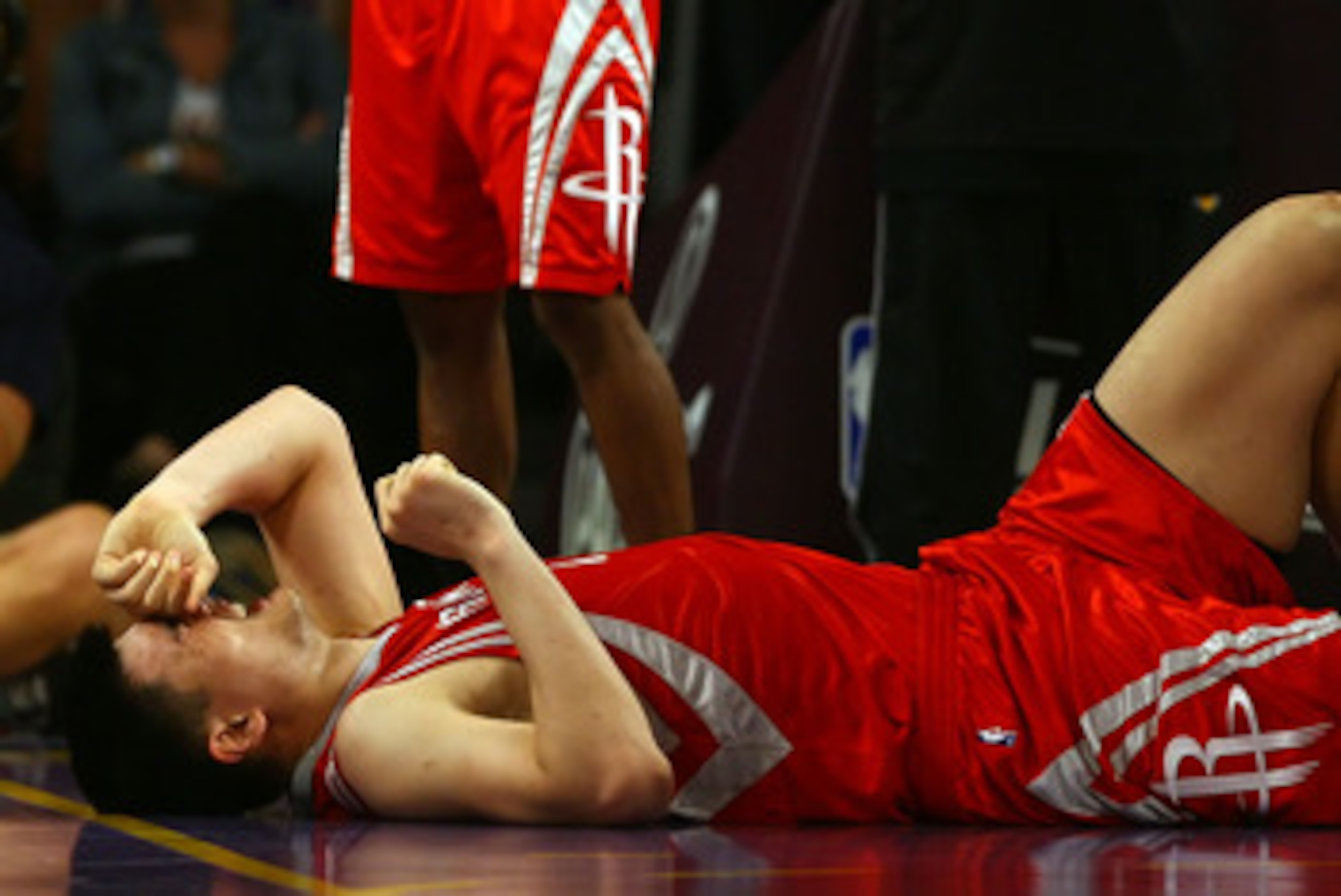 LOS ANGELES, CA - MAY 04:  Yao Ming #11 of the Houston Rockets reacts in pain after injuring his knee in the fourth quarter against the Los Angeles Lakers in Game One of the Western Conference Semifinals during the 2009 NBA Playoffs at Staples Center on M