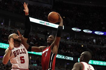 CHICAGO, IL - MAY 26:  Chris Bosh #1 of the Miami Heat drives for a shot attempt against Carlos Boozer #5 and Luol Deng #9 of the Chicago Bulls in Game Five of the Eastern Conference Finals during the 2011 NBA Playoffs on May 26, 2011 at the United Center