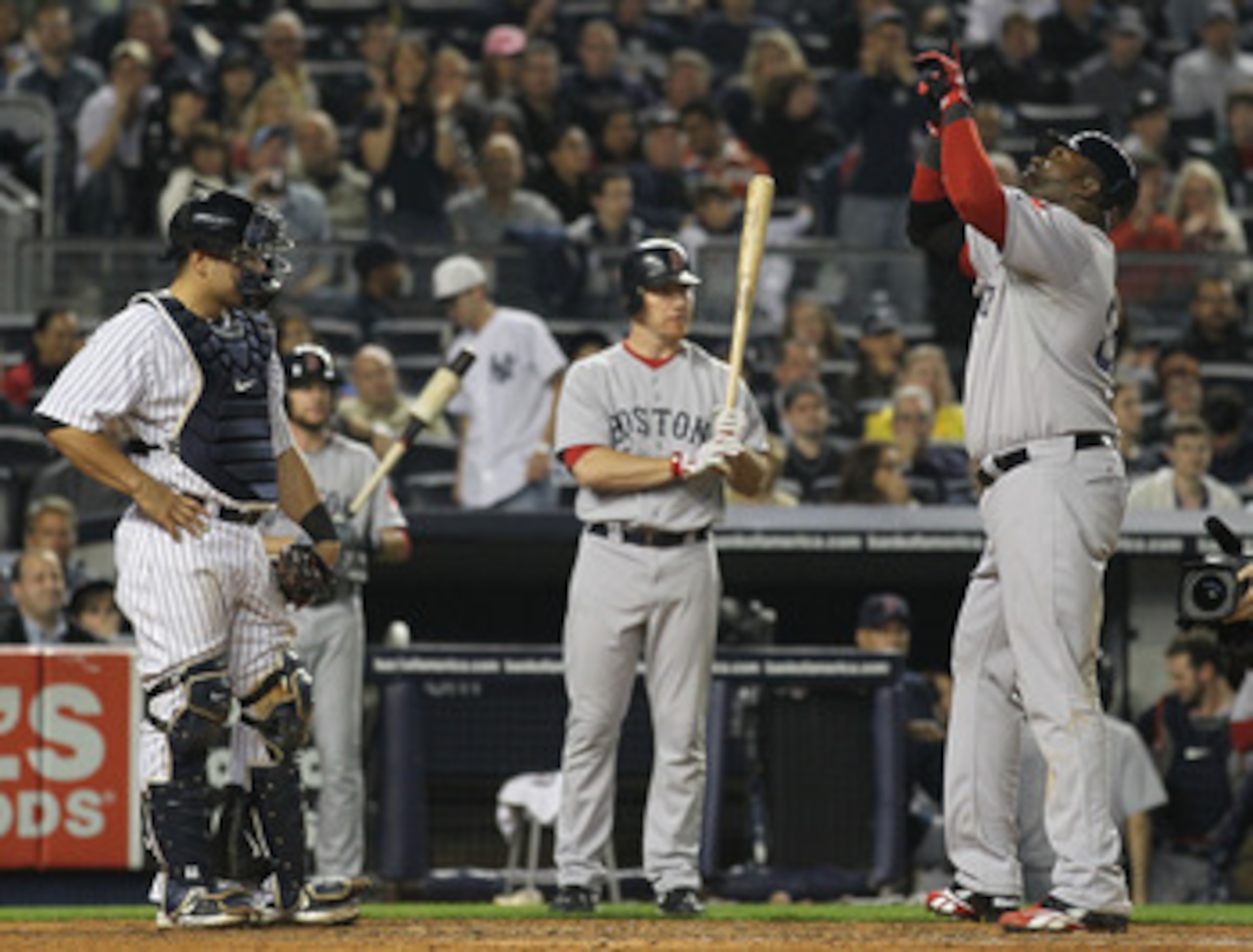 NEW YORK, NY - MAY 15:  David Ortiz #34 of the Boston Red Sox celebrates a home run in the fifth inning as Russell Martin #55 of the New York Yankees looks on during their game on May 15, 2011 at Yankee Stadium in the Bronx borough of New York City.  (Pho