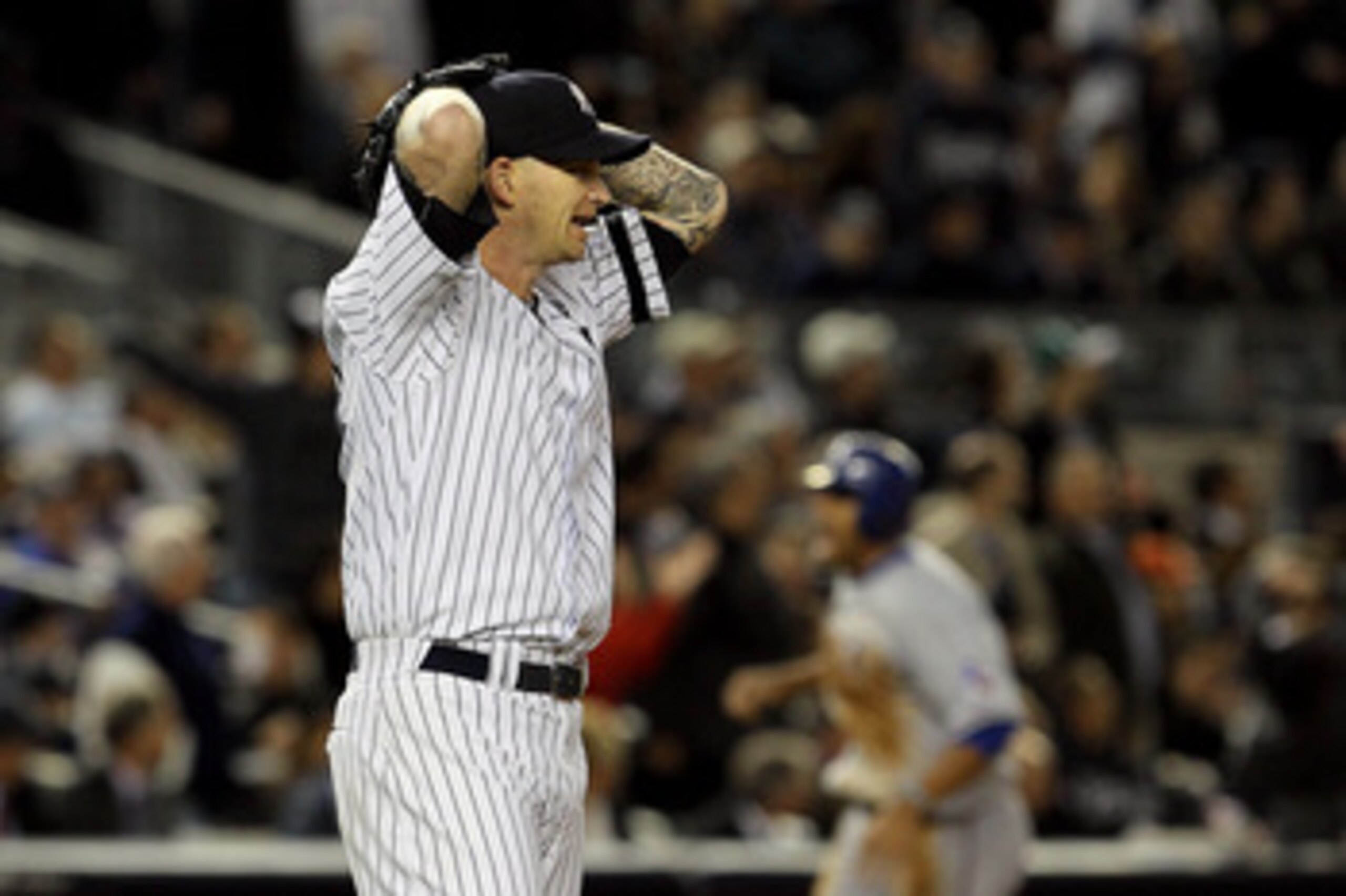 NEW YORK - OCTOBER 19:  A.J. Burnett #34 of the New York Yankees reacts after giving up a three-run home run to Bengie Molina #11 of the Texas Rangers in the top of the sixth inning in Game Four of the ALCS during the 2010 MLB Playoffs at Yankee Stadium o