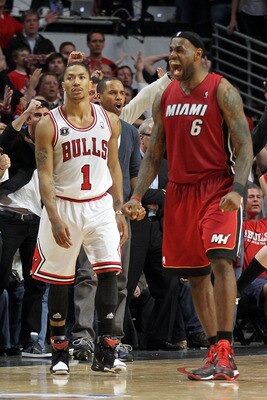CHICAGO, IL - MAY 26:  Derrick Rose #1 of the Chicago Bulls looks on dejected as LeBron James #6 of the Miami Heat celebrates after the Heat won 83-80 in Game Five of the Eastern Conference Finals during the 2011 NBA Playoffs on May 26, 2011 at the United