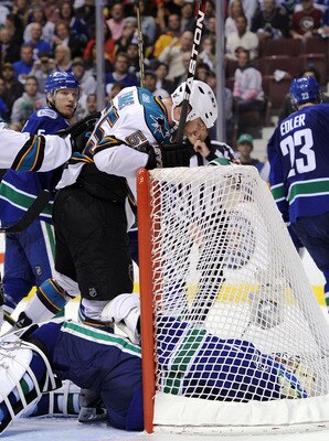 VANCOUVER, BC - MAY 18:  Ben Eager #55 of the San Jose Sharks stands over and taunts goaltender Roberto Luongo #1 of the Vancouver Canucks after scoring a goal late in the third period in Game Two of the Western Conference Finals during the 2011 Stanley C