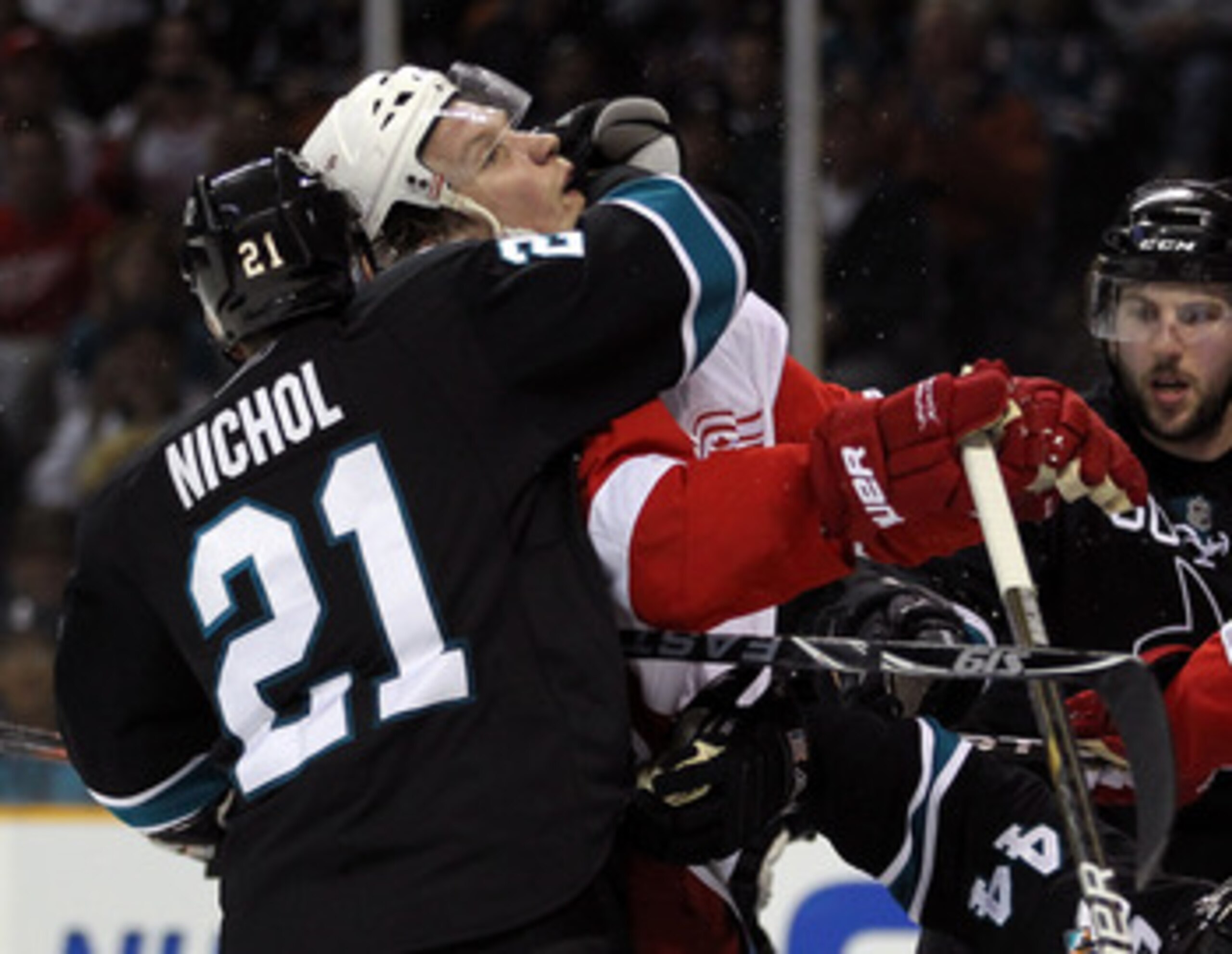 SAN JOSE, CA - MAY 12: Scott Nichol #21 of the San Jose Sharks wraps his arm around Justin Abdelkader #8 of the Detroit Red Wings in Game Seven of the Western Conference Semifinals during the 2011 NHL Stanley Cup Playoffs at HP Pavilion on May 12, 2011 in