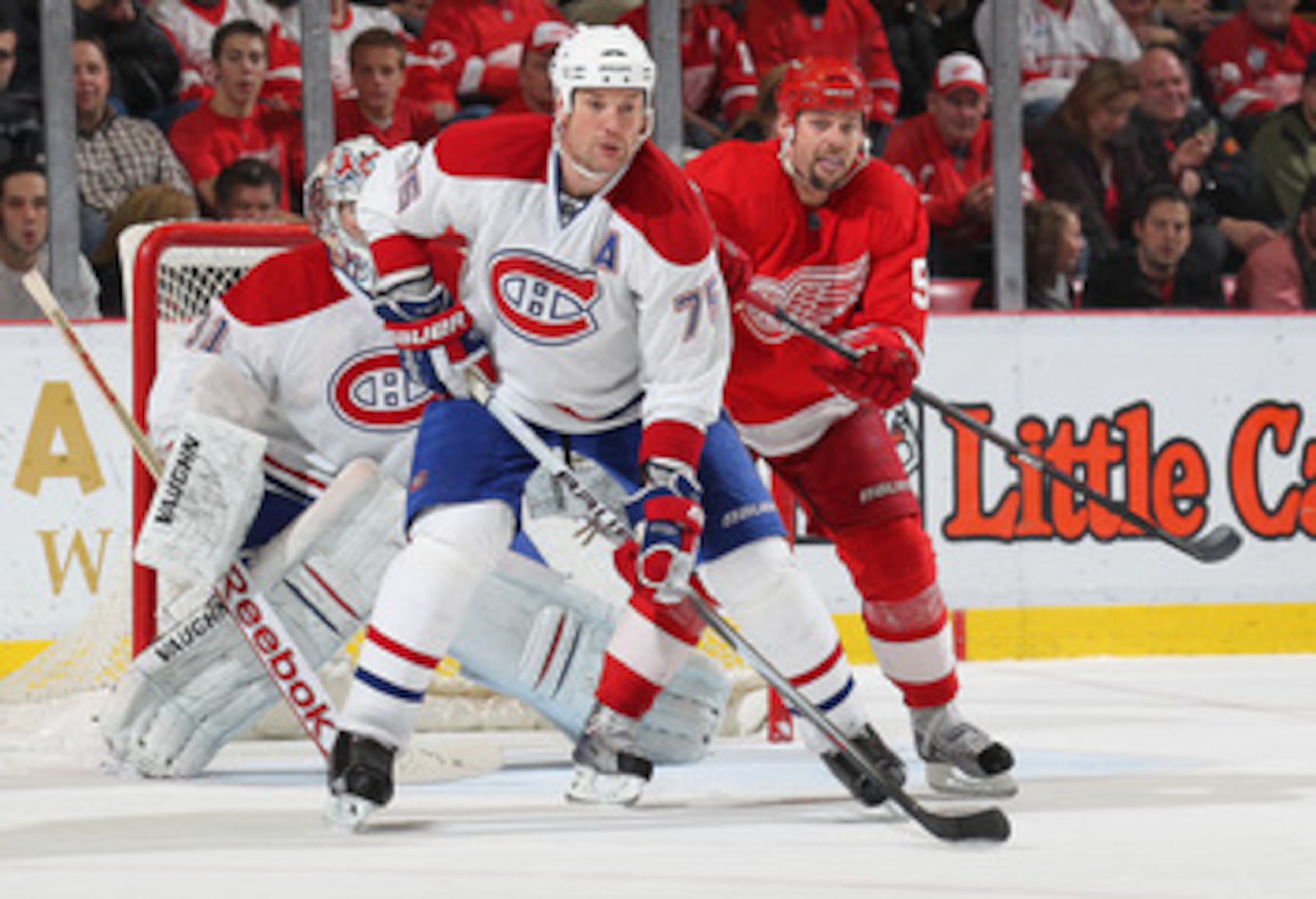 DETROIT,MI - DECEMBER 10:  Hal Gill #75 of the Montreal Canadiens works to keep Tomas Holmstrom #96 of the Detroit Red Wings in check in a game on December 10, 2010 at the Joe Louis Arena in Detroit, Michigan. The Wings defeated the Canadiens 4-2. (Photo