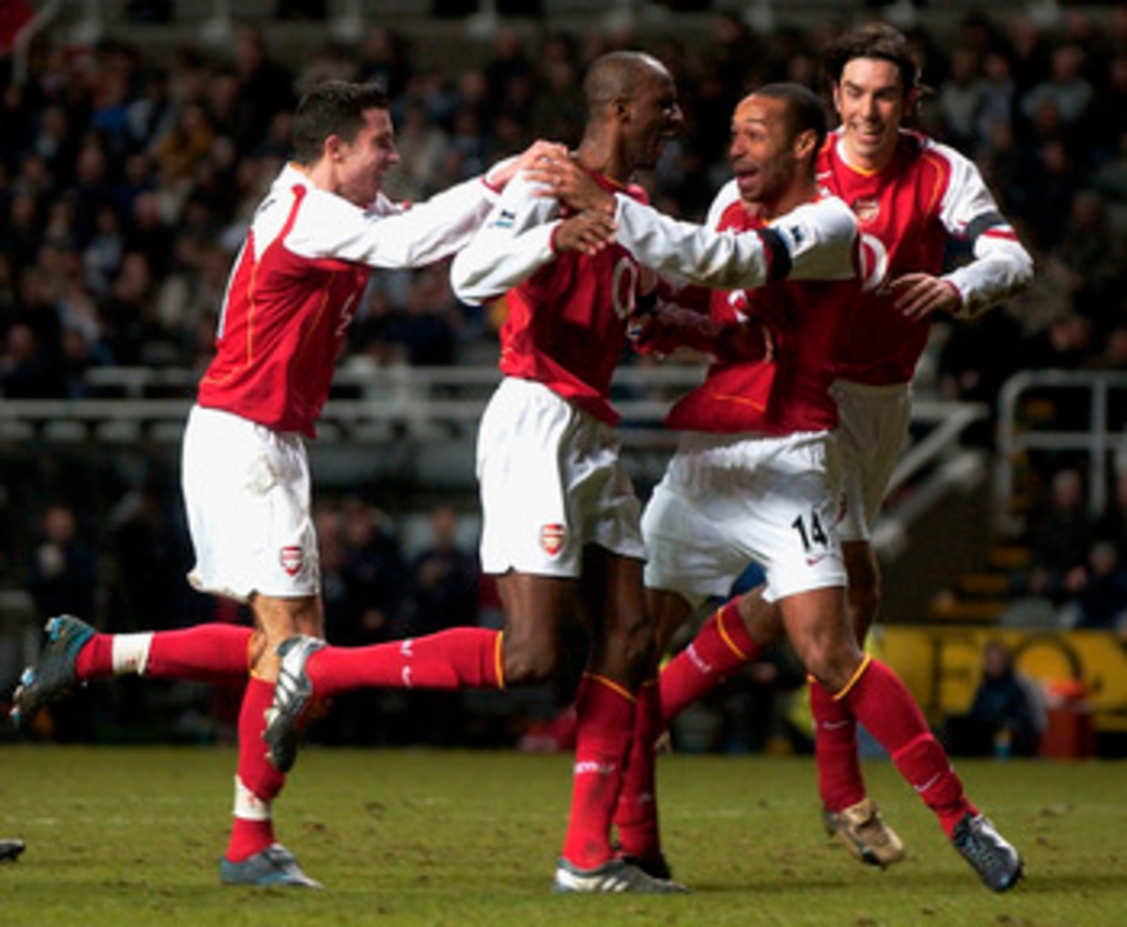 NEWCASTLE, ENGLAND - DECEMBER 29: Thierry Henry of Arsenal congratulates Patrick Vieira on his goal during the FA Barclays Premiership match between Newcastle United and Arsenal at St.James Park on December 29, 2004 in Newcastle, England. (Photo by Matthe
