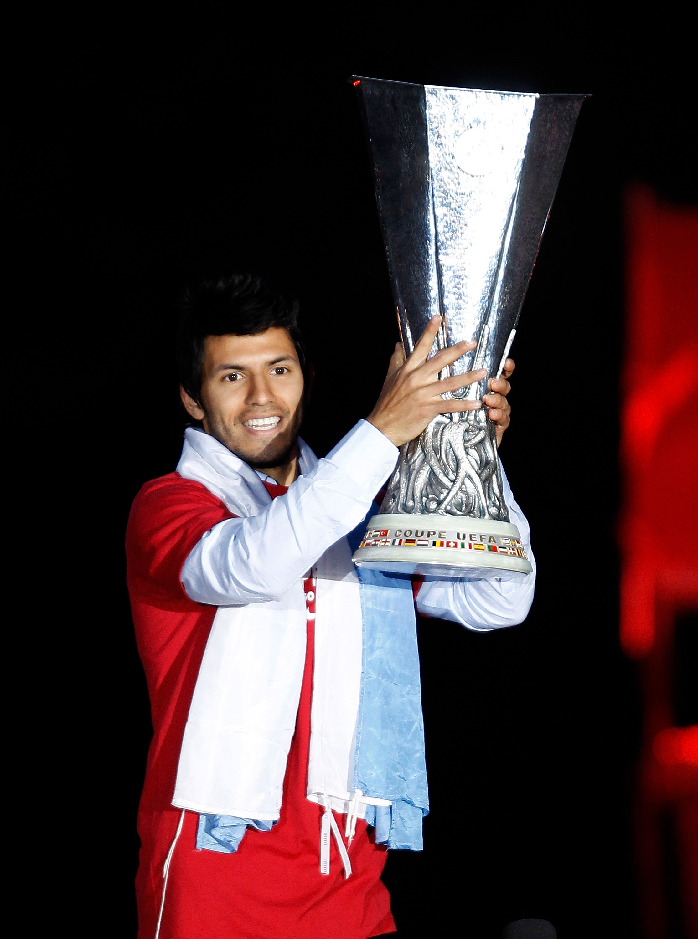 MADRID, SPAIN - MAY 13:  Atletico Madrid player Sergio Aguero celebrates with the trophy at the Neptuno fountain in Madrid the day after Atletico won the UEFA Europa League Cup final on May 13, 2010 in Madrid, Spain. Atletico beat Fulham in the final in H