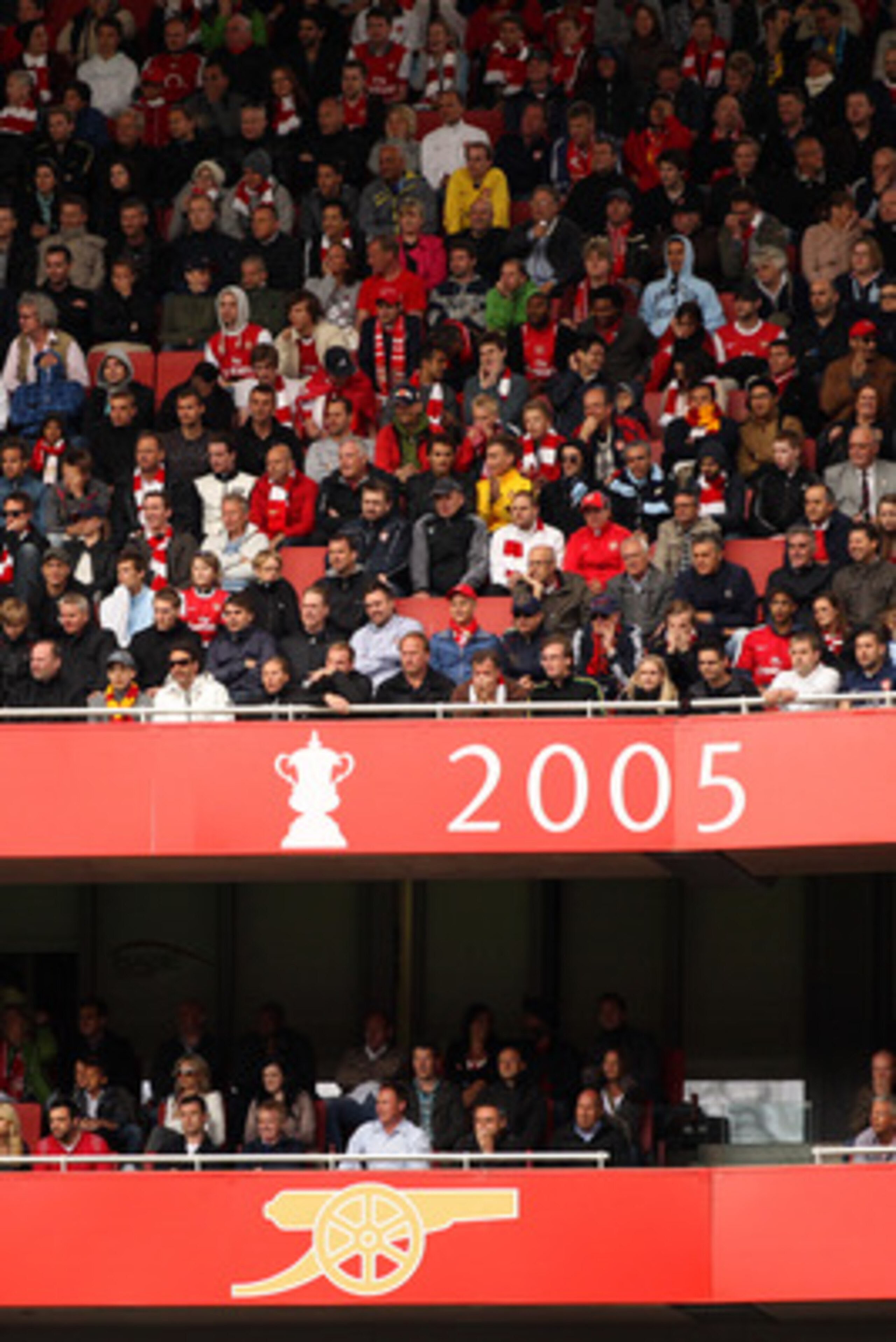 LONDON, ENGLAND - MAY 15:  Arsenal fans watch the action from their seats behind a sign displaying the last trophy that the club won in 2005 during the Barclays Premier League match between Arsenal and Aston Villa at the Emirates Stadium on May 15, 2011 i