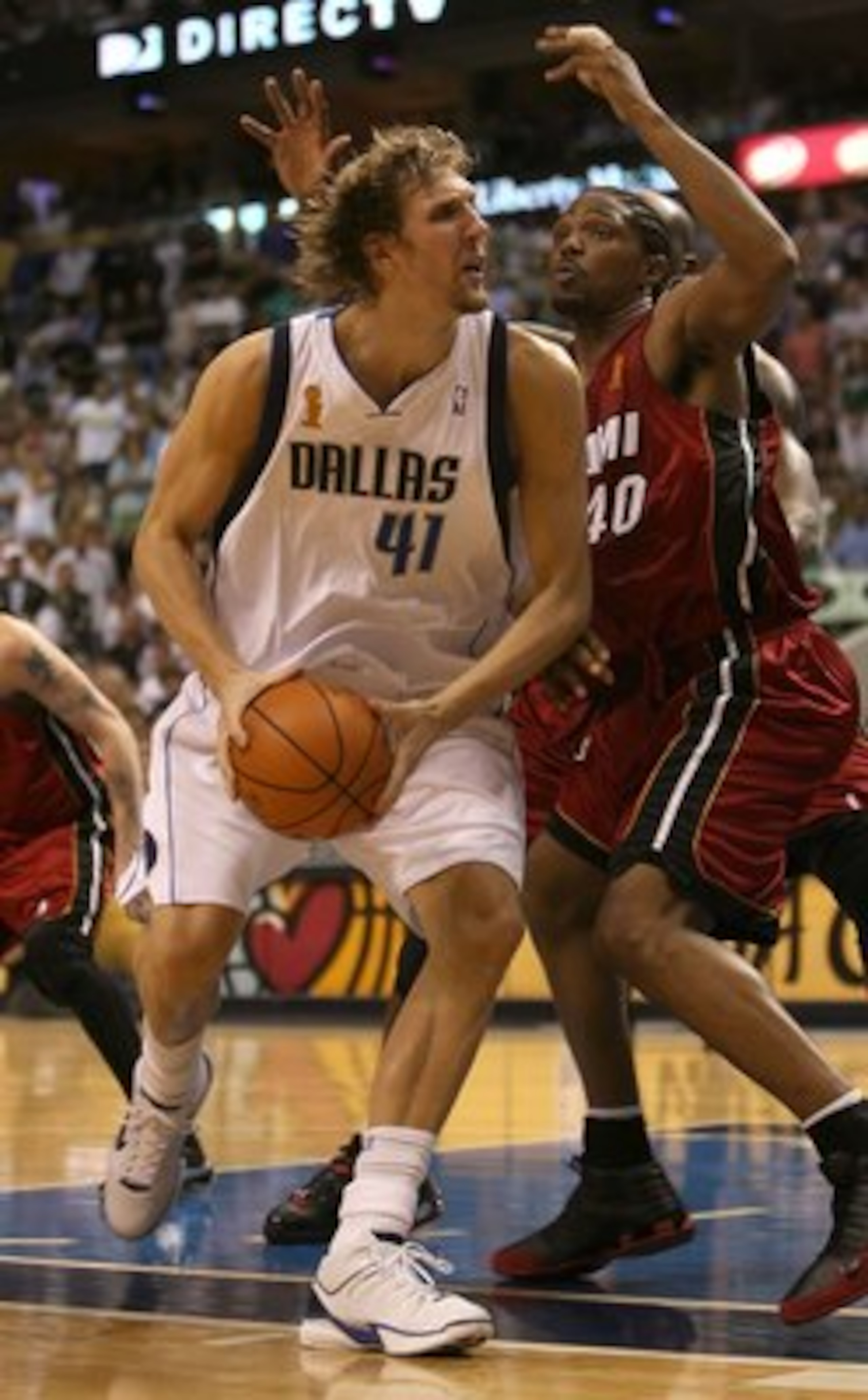 DALLAS - JUNE 20:  Dirk Nowitzki #41 of the Dallas Mavericks moves around Udonis Haslem #40 of the Miami Heat in the third quarter of game six of the 2006 NBA Finals on June 20, 2006 at American Airlines Center in Dallas, Texas.  NOTE TO USER: User expres