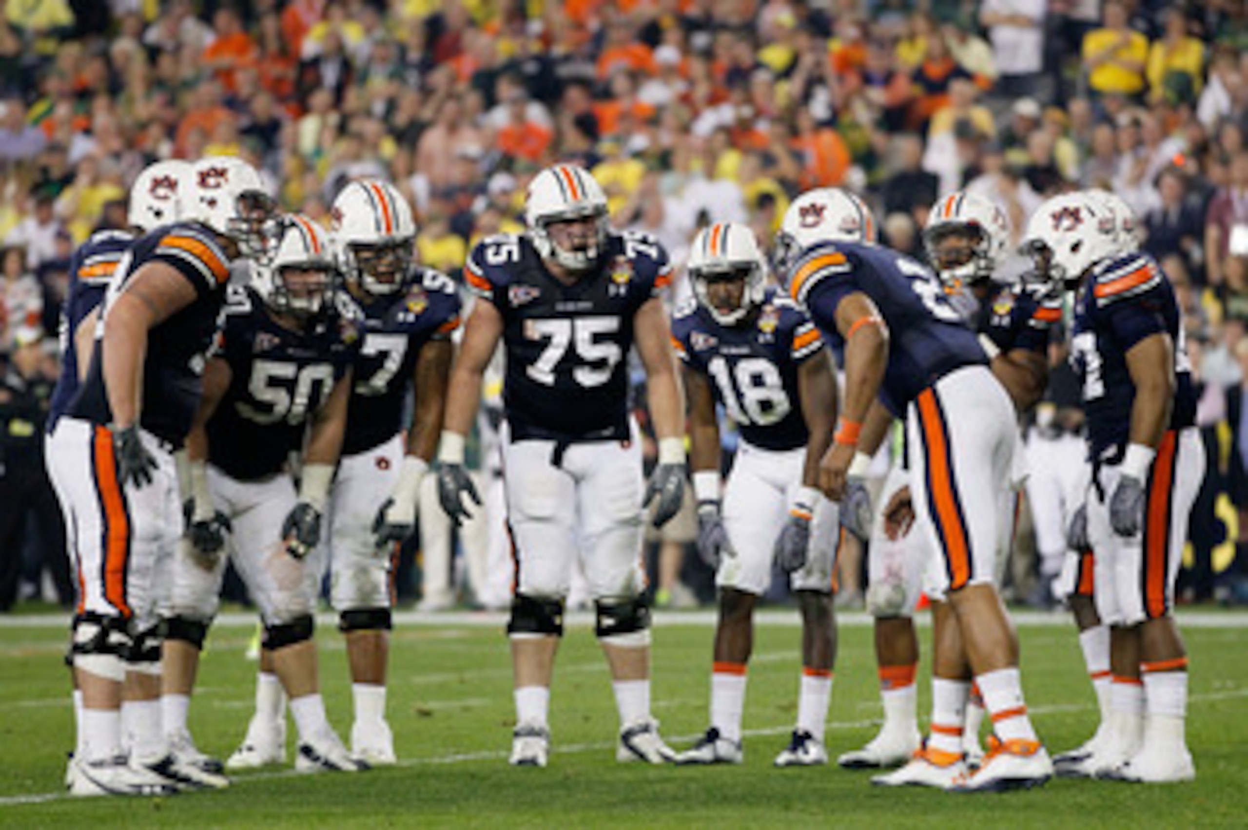 GLENDALE, AZ - JANUARY 10:  The Auburn Tigers huddle against the Oregon Ducks during the Tostitos BCS National Championship Game at University of Phoenix Stadium on January 10, 2011 in Glendale, Arizona.  (Photo by Kevin C. Cox/Getty Images)