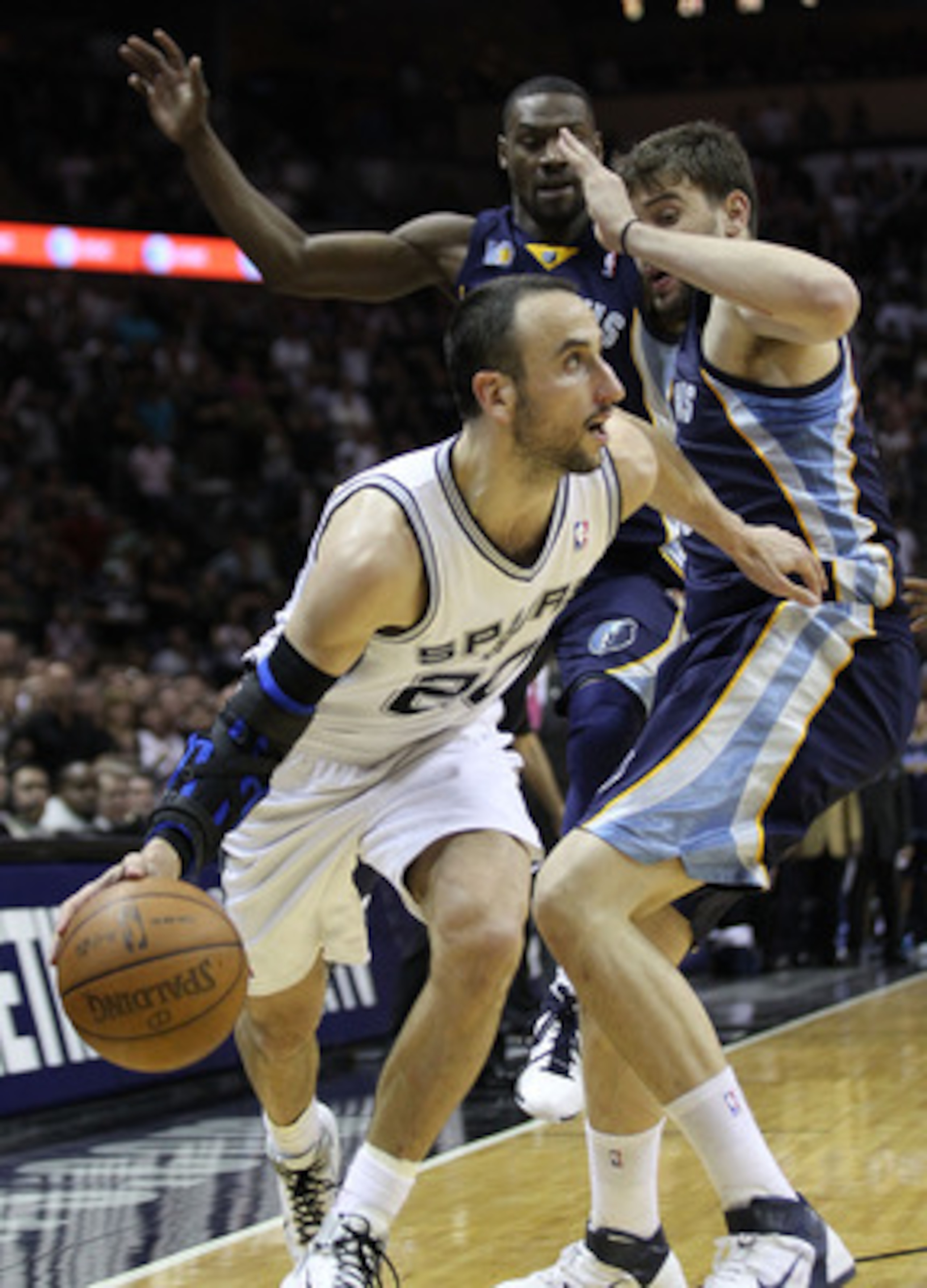 SAN ANTONIO, TX - APRIL 27:  Manu Ginobili #20 of the San Antionio Spurs drives against Marc Gasol #33 of the Memphis Grizzlies in Game Five of the Western Conference Quarterfinals in the 2011 NBA Playoffs on April 27, 2011 at AT&T Center in San Antonio,