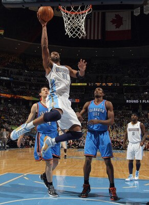 DENVER, CO - APRIL 23:  Nene Hilario #31 of the Denver Nuggets lays up a shot in front of Nick Collison #4 and Serge Ibaka #9 of the Oklahoma City Thunder in Game Three of the Western Conference Quarterfinals in the 2011 NBA Playoffs on April 23, 2011 at