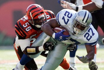 CINCINNATI - NOVEMBER 7:  Brian Simmons #56 of the Cincinnati Bengals tackles Eddie George #27 of the Dallas Cowboys at Paul Brown Stadium November 7, 2004 in Cincinnati, Ohio. Cincinnati won 26-3.  (Photo by Andy Lyons/Getty Images)