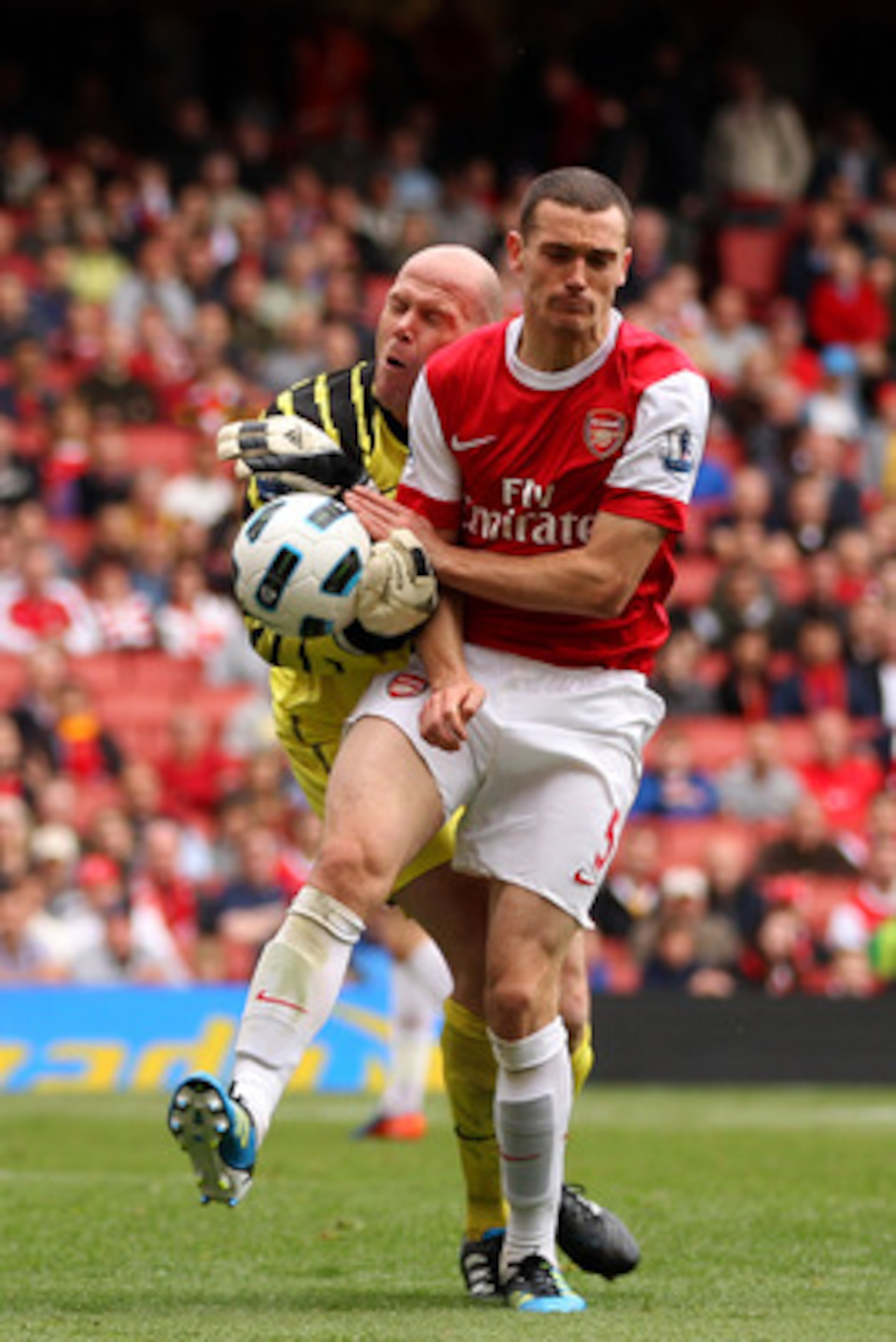 LONDON, ENGLAND - MAY 15:  Thomas Vermaelen (R) of Arsenal collides with Brad Friedel of Aston Villa during the Barclays Premier League match between Arsenal and Aston Villa at the Emirates Stadium on May 15, 2011 in London, England.  (Photo by Richard He