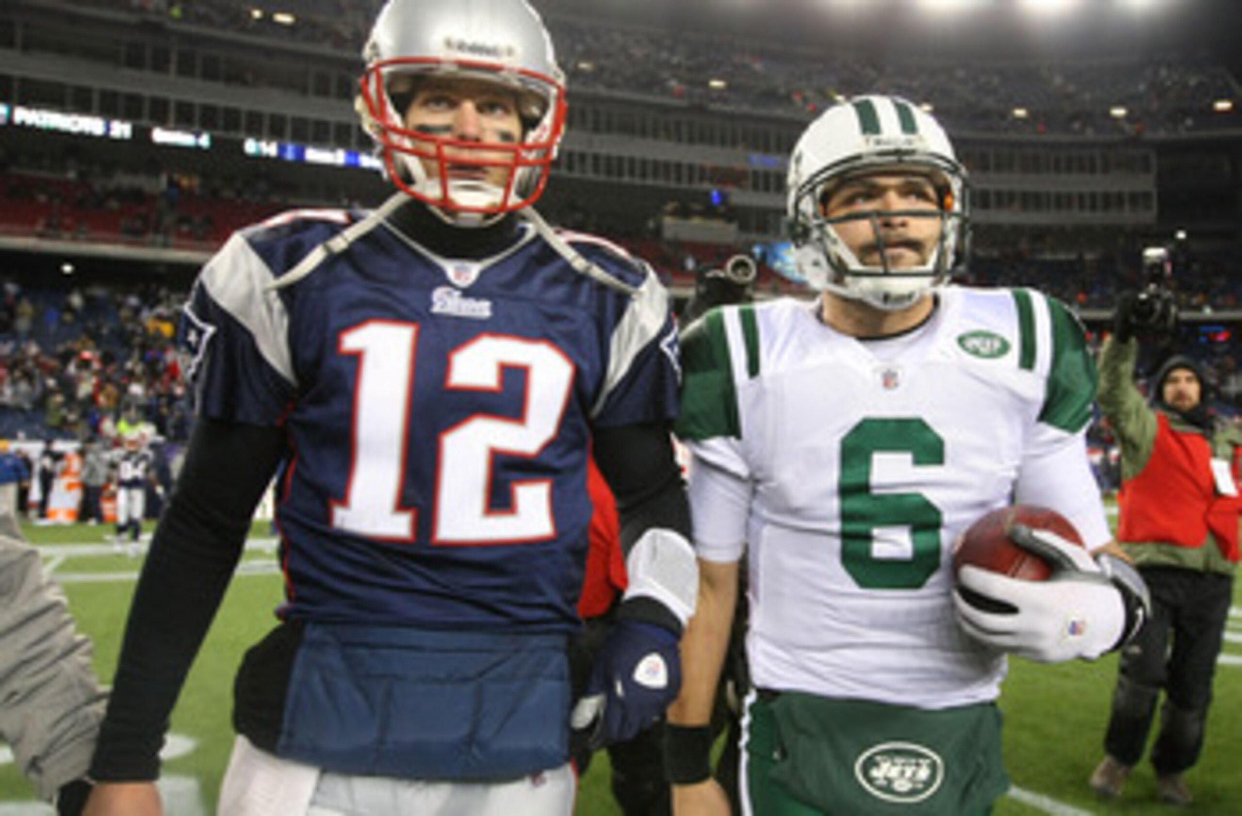 FOXBORO, MA - JANUARY 16:  Tom Brady #12 of the New England Patriots and Mark Sanchez #6 of the New York Jets walk off the field after the Jets defeated the Patriots 28 to 21 their 2011 AFC divisional playoff game at Gillette Stadium on January 16, 2011 i