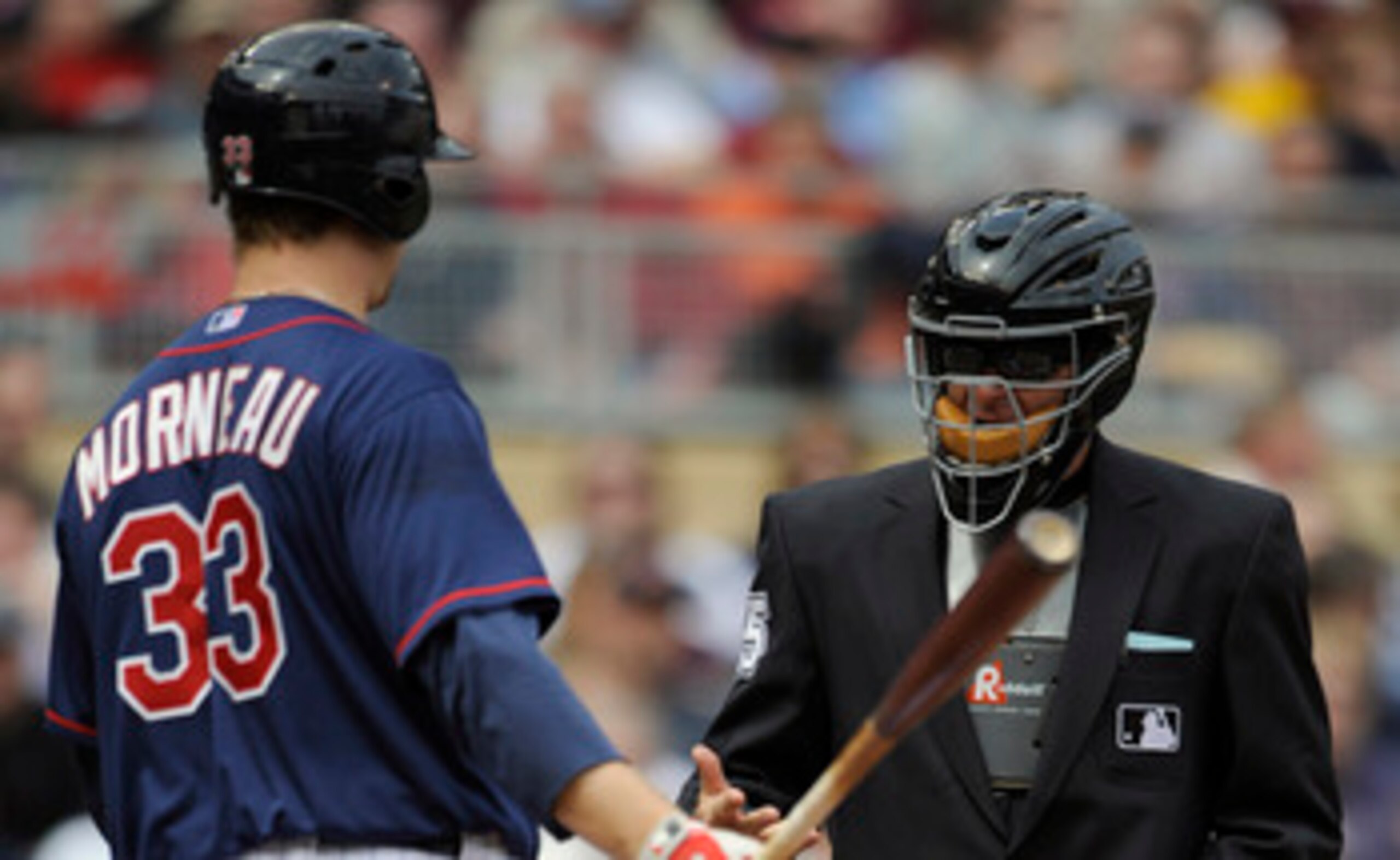 MINNEAPOLIS, MN - APRIL 13: Justin Morneau #33 of the Minnesota Twins speaks with home plate umpire Ed Hickox #15 during the seventh inning of their game against Kansas City Royals on April 13, 2011 at Target Field in Minneapolis, Minnesota. Royals defeat
