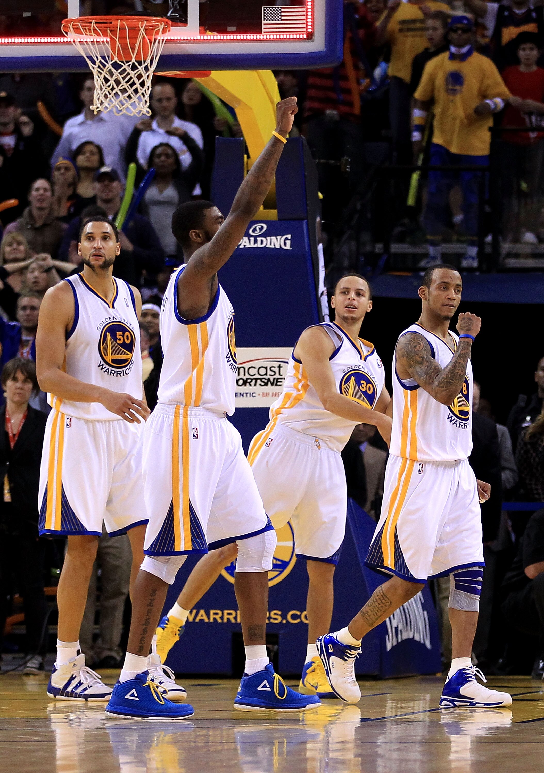 OAKLAND, CA - JANUARY 21:  Dan Gadzuric #50, Dorell Wright #1, Stephen Curry #30 and Monta Ellis #8 of the Golden State Warriors reacts after the Warriors sent their game against the Sacramento Kings into overtime at Oracle Arena on January 21, 2011 in Oa