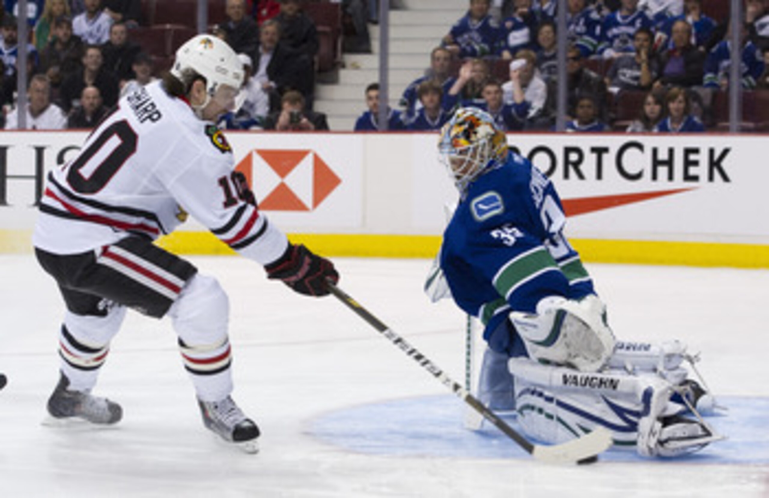 VANCOUVER, CANADA - APRIL 21: Goalie Cory Schneider #35 of the Vancouver Canucks gets his pad down to stop Patrick Sharp #10 of the Chicago Blackhawks during the third period in Game Five of the Western Conference Quarterfinals during the 2011 NHL Stanley VANCOUVER, CANADA - APRIL 21: Goalie Cory Schneider #35 of the Vancouver Canucks gets his pad down to stop Patrick Sharp #10 of the Chicago Blackhawks during the third period in Game Five of the Western Conference Quarterfinals during the 2011 NHL Stanley