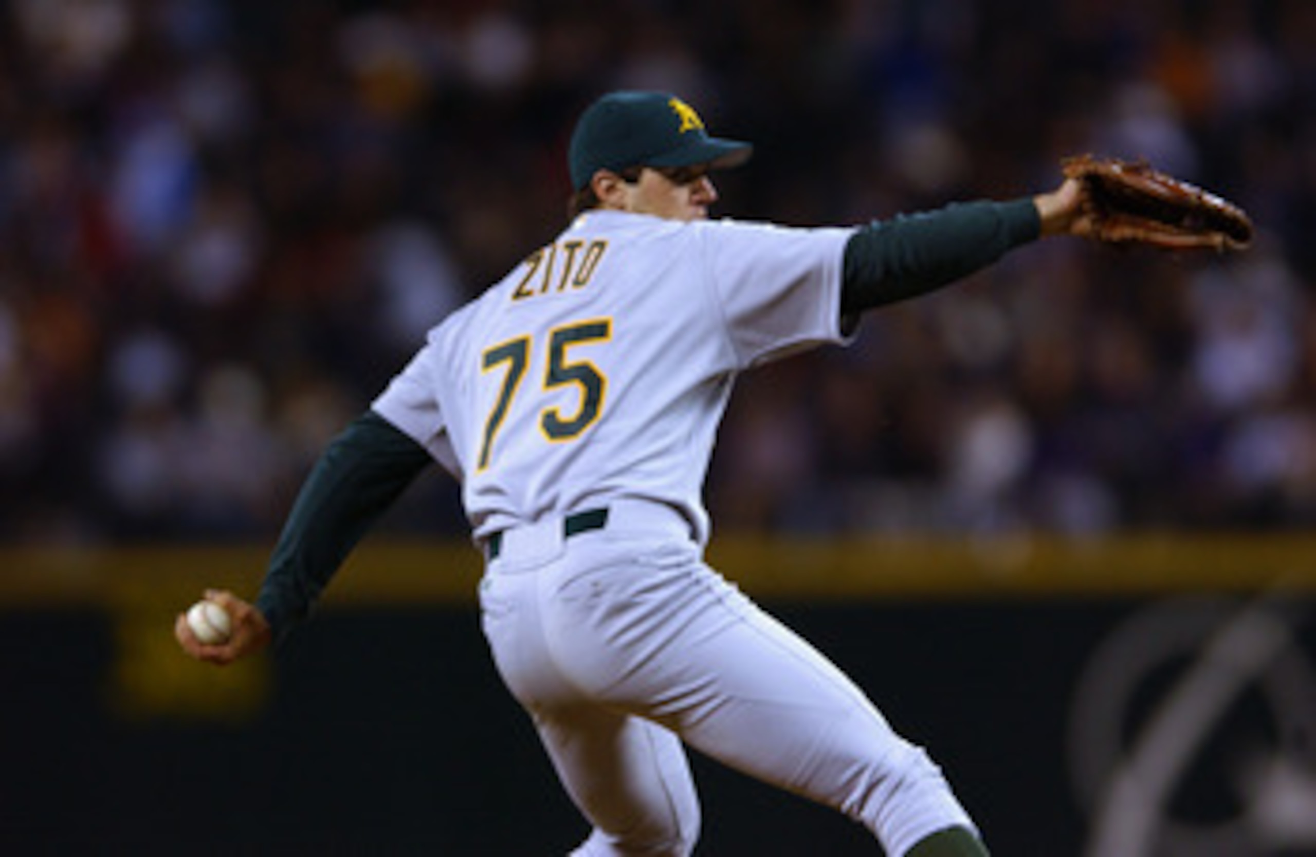 SEATTLE - SEPTEMBER 24:  Starting Pitcher Barry Zito #75 of the Oakland A's delivers a pitch against the Seattle Mariners during the game on September 24, 2002 at Safeco Field in Seattle, Washington.  The Mariners defeated the A's 8-7.  (Photo by Otto Gre