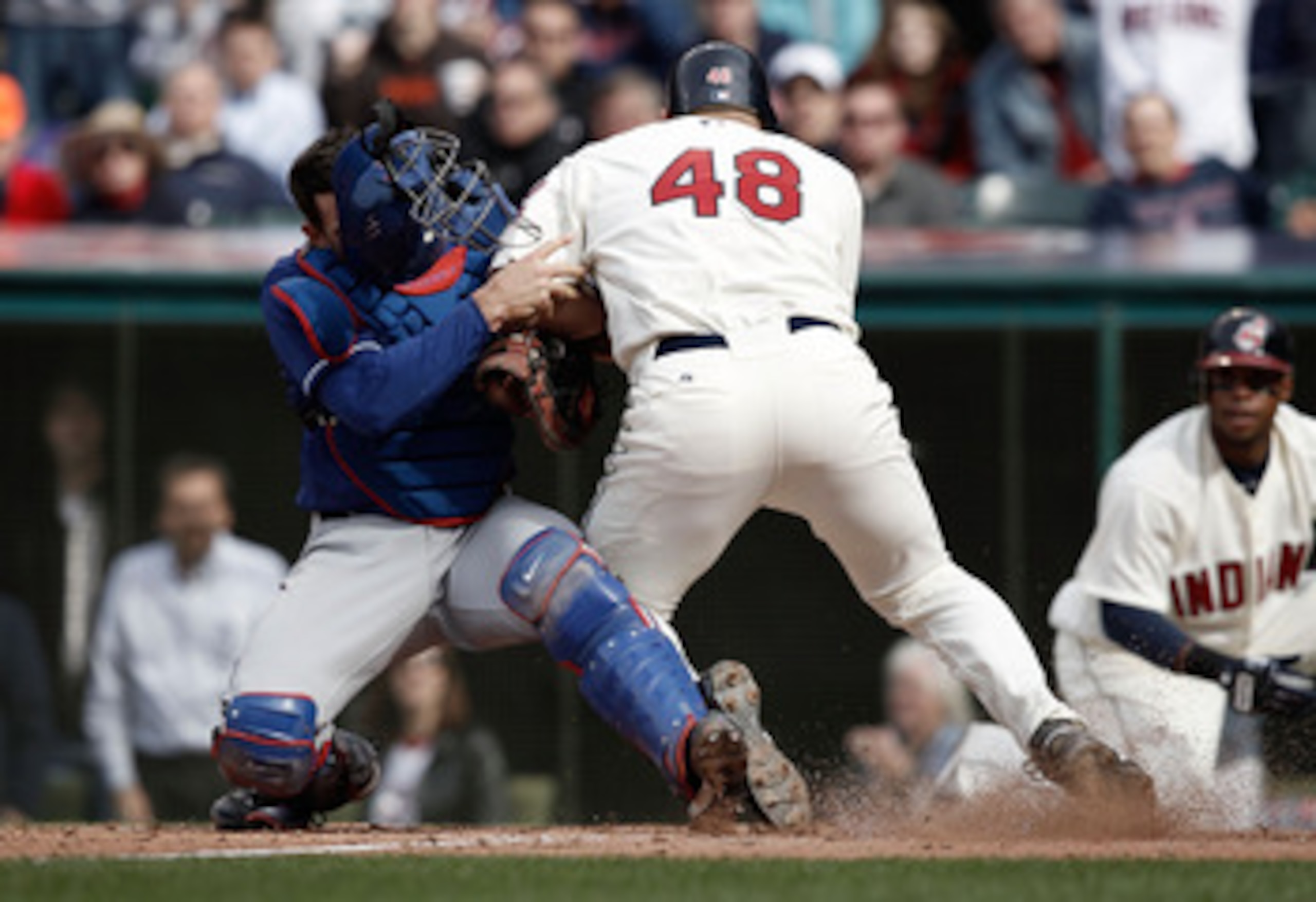 CLEVELAND, OH- APRIL 12: Taylor Teagarden #2 of the Texas Rangers tags out Travis Hafner #48 of the Cleveland Indians while colliding with him at home plate during the Opening Day game on April 12, 2010 at Progressive Field in Cleveland, Ohio.  (Photo by